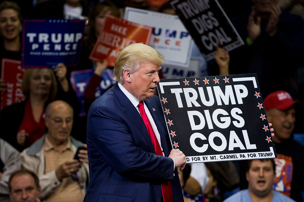 Republican presidential nominee Donald Trump holds a sign supporting coal during a rally at Mohegan Sun Arena in Wilkes-Barre, Pennsylvania on October 10, 2016. (Credit: DOMINICK REUTER/AFP/Getty Images)