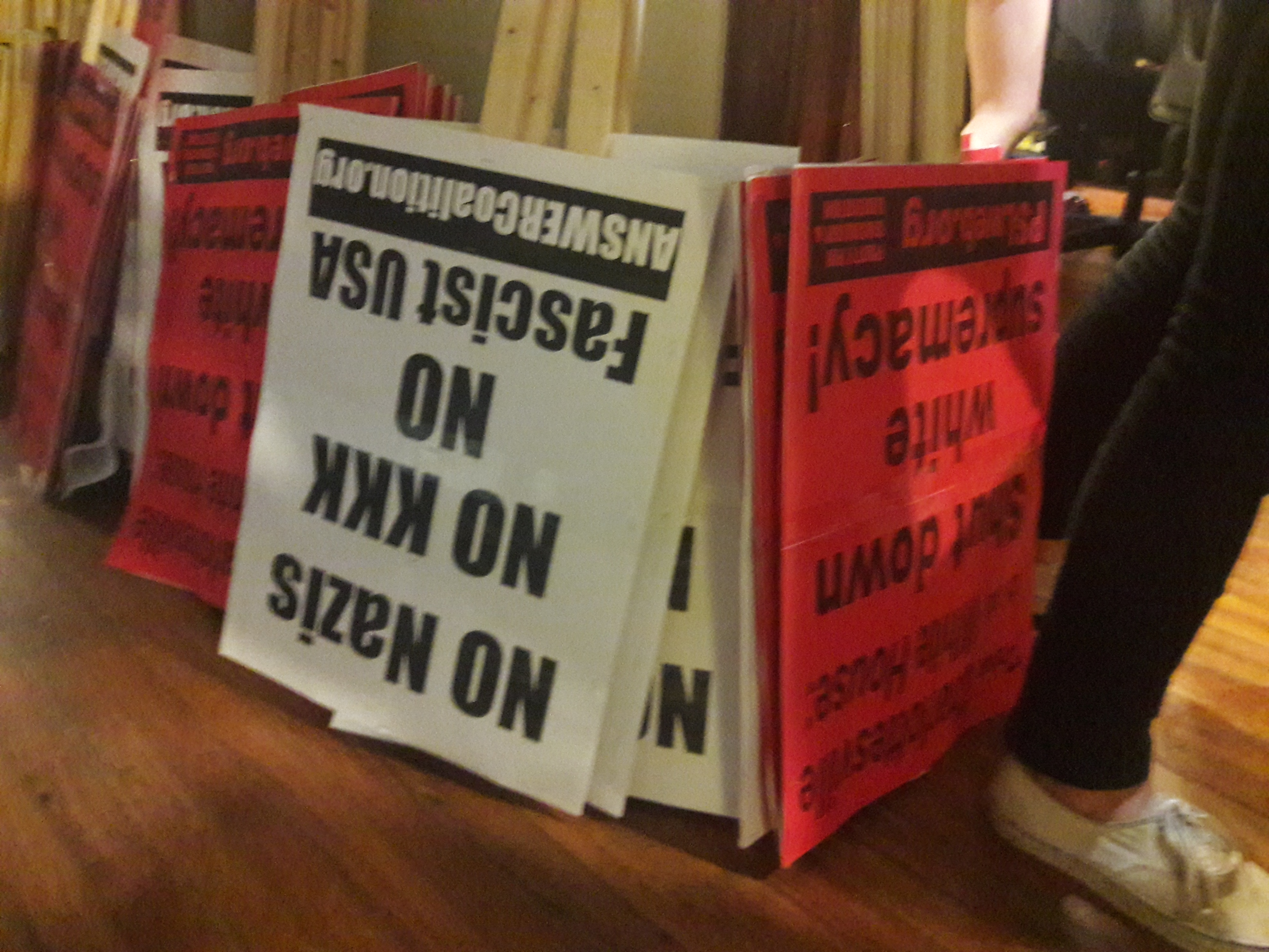 Signs in progress at the ANSWER Coalition event on August 9, 2018, to prepare for protesting Unite the Right 2. CREDIT: Dorothy Parvaz