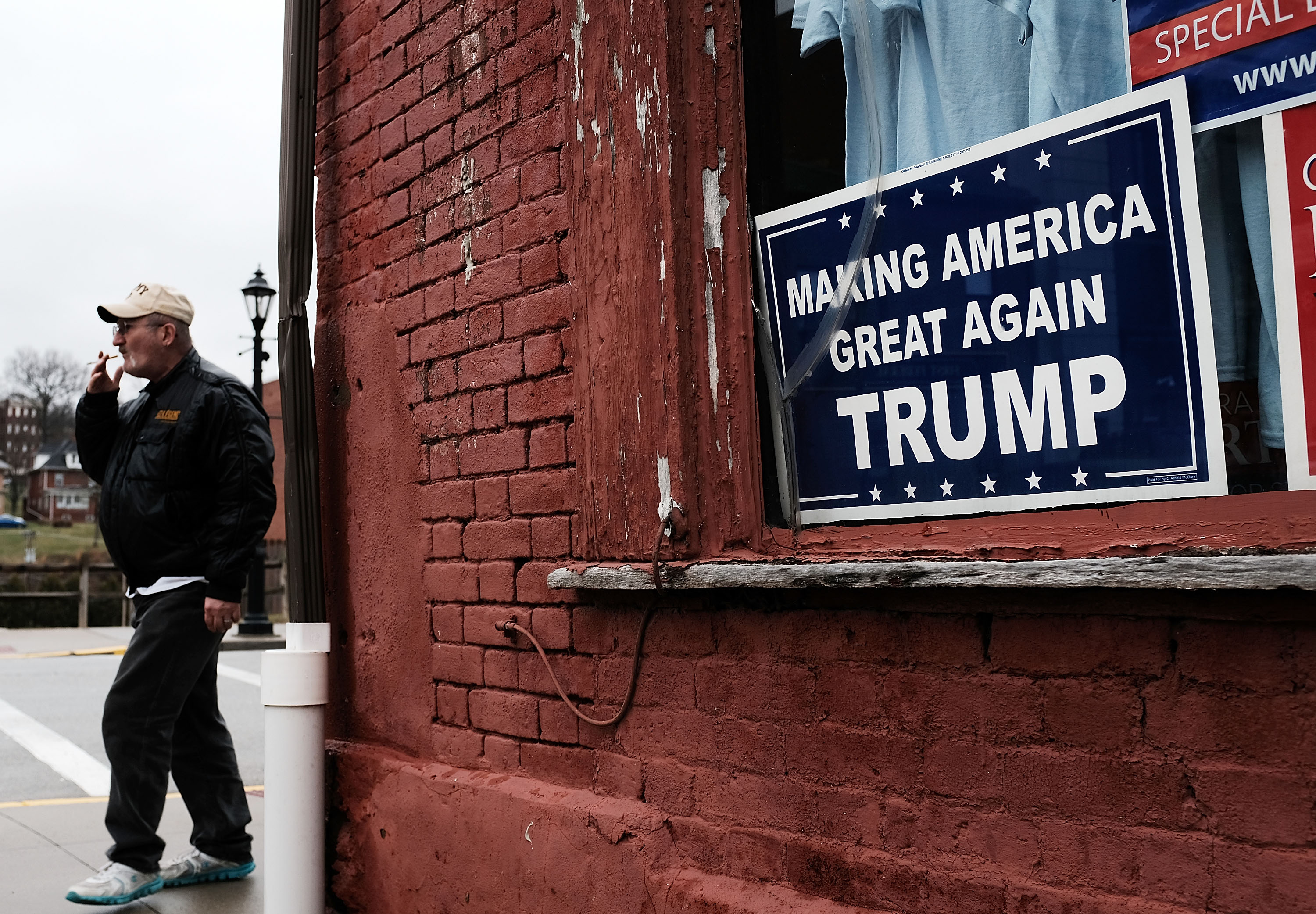 A Donald Trump sign hangs in the window in the town of Waynesburg, Pennsylvania, near the West Virginia border on March 1, 2018. Waynesburg, once a thriving coal industry center, has struggled to find its footing under Trump and previous presidents. CREDIT: Spencer Platt/Getty Images