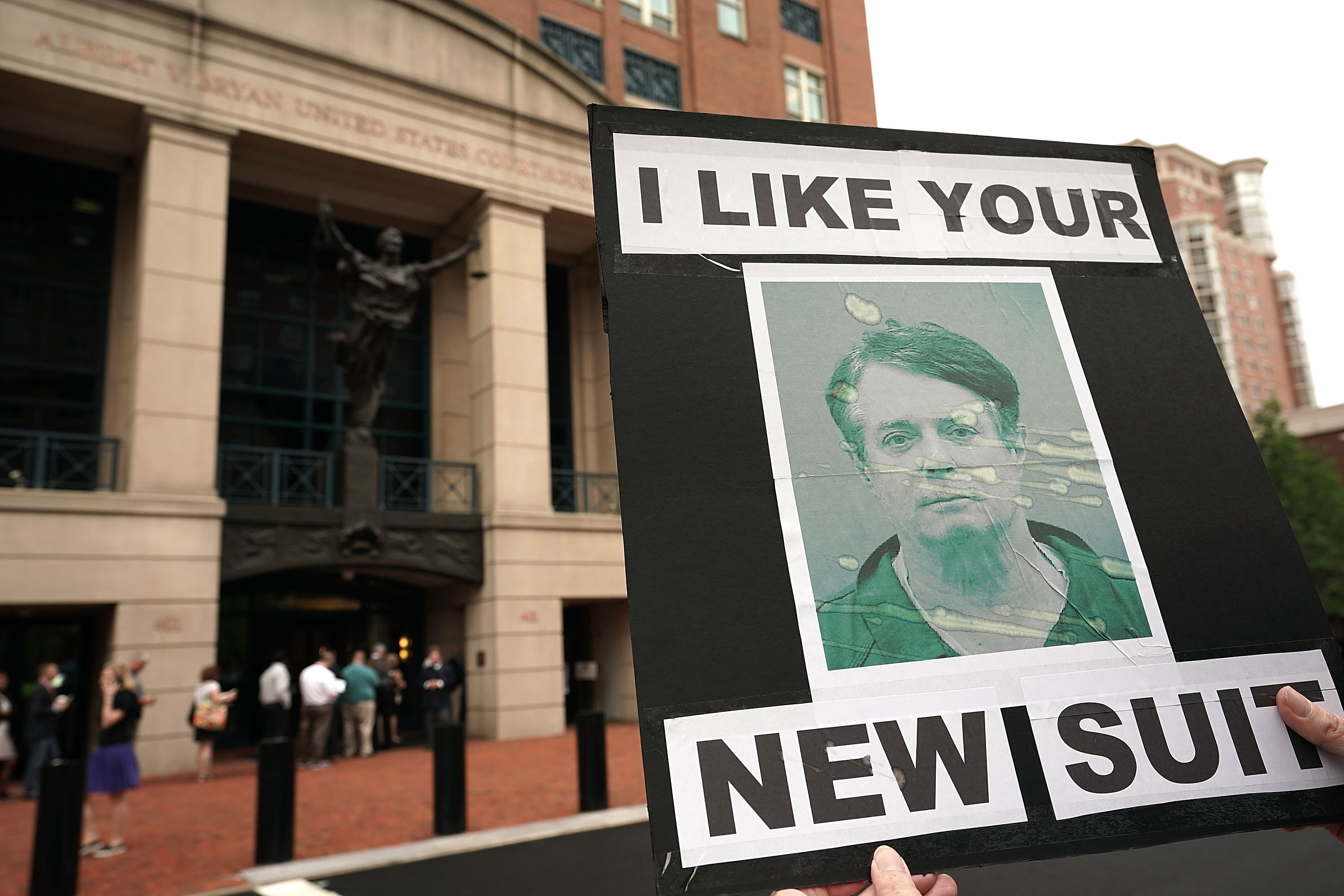 An activist holds a picture of former Trump campaign chairman Paul Manafort during a protest outside the Albert V. Bryan United States Courthouse. (Photo by Alex Wong/Getty Images)