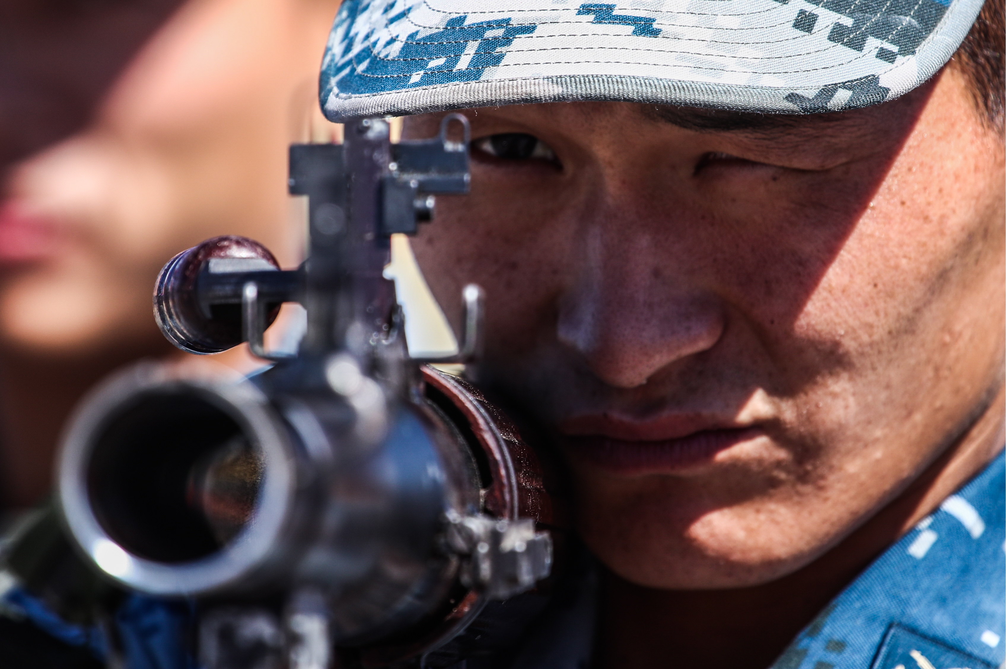 A participant from the People's Republic of China competes in a relay race incorporating an obstacle course for air assault units with small arms during the Airborne Platoon contest at the 2018 International Army Games. (PHOTO CREDIT: Valery SharifulinTASS via Getty Images)