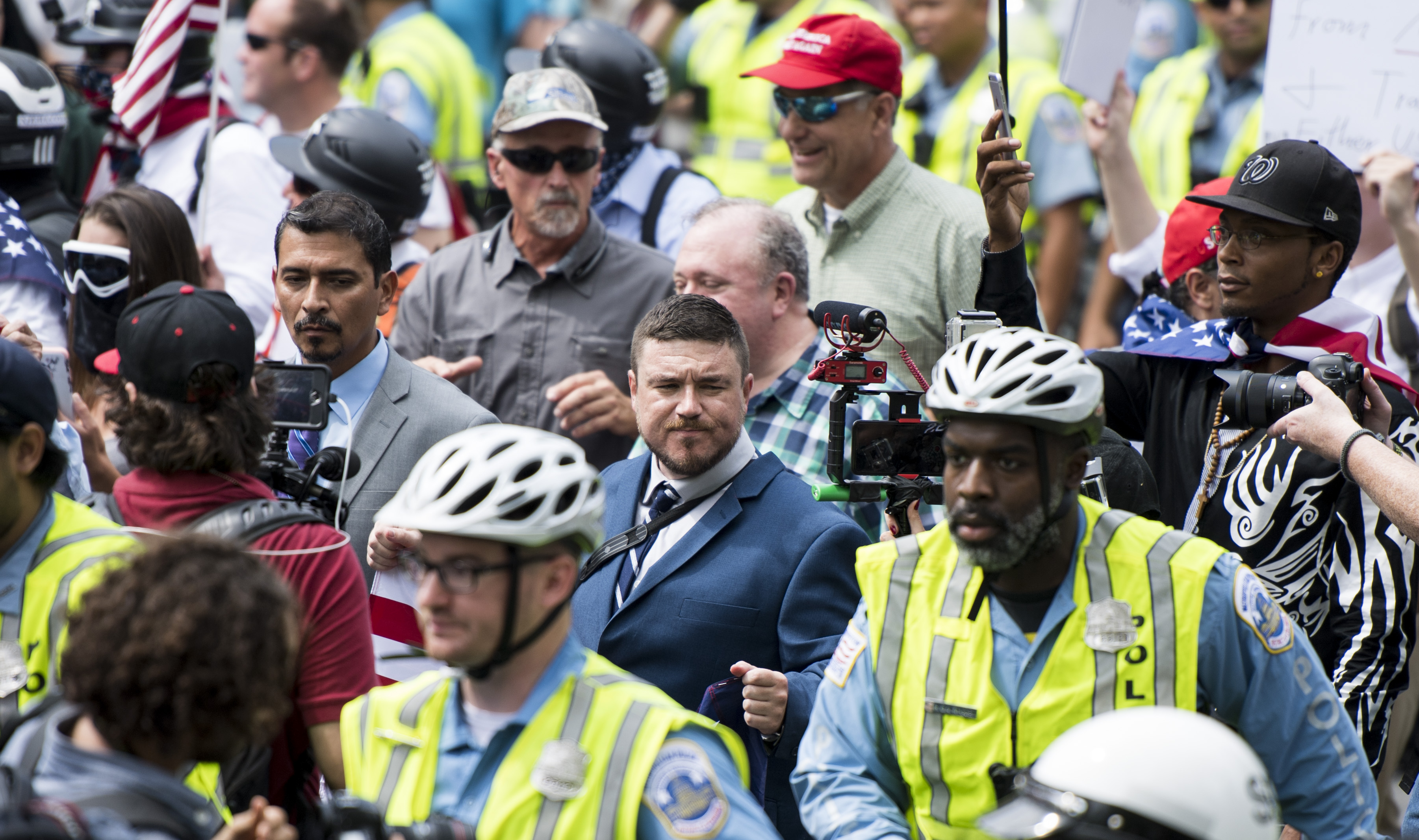 Jason Kessler, center, organizer of the Unite the Right protest, marches with a couple dozen white nationalists under police escort to their rally in Lafayette Square across from the White House on the anniversary of the Charlottesville protest on August 12, 2018. CREDIT: Bill Clark/CQ Roll Call