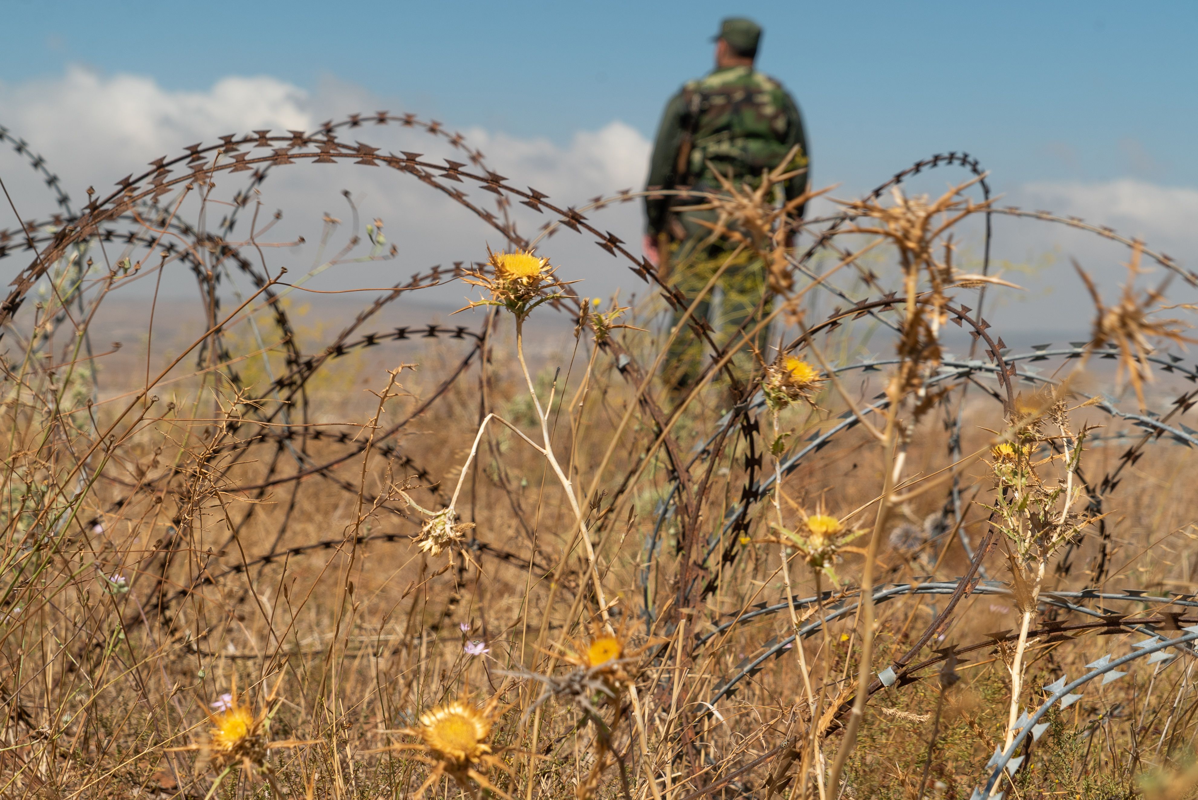 A member of the Syrian government forces patrols near the village of Tal Krum in the Syrian Golan Heights on August 14, 2018. CREDIT: Andrey Borodulin/AFP/Getty Images.