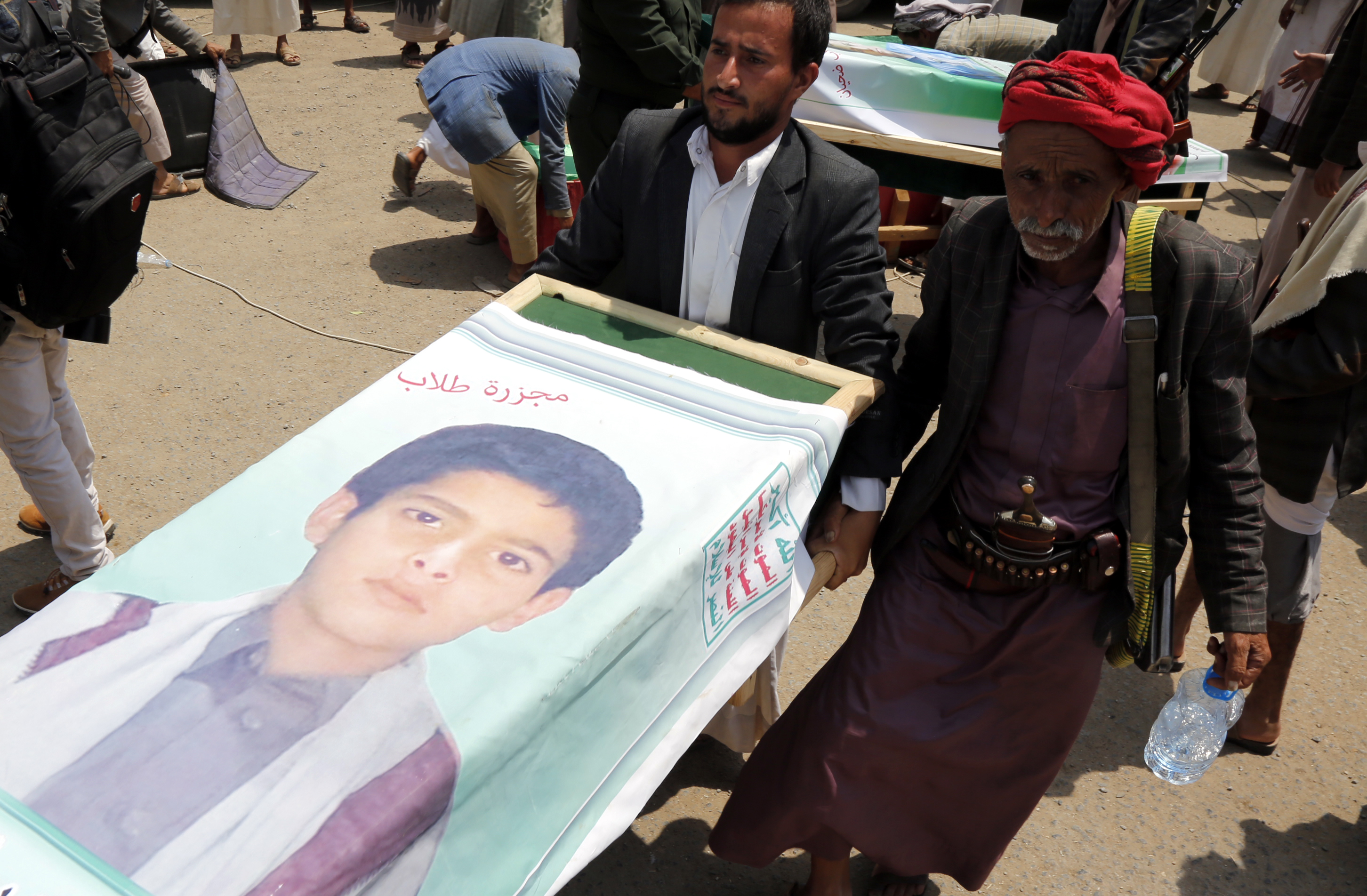 Mourners carry the coffin of a child at the funeral procession for those killed in an airstrike on a bus carried out last week by a warplane of the Saudi Arabia-led coalition on August 13, 2018 in Saada, Yemen. (PHOTO CREDIT: Mohammed Hamoud/Getty Images)