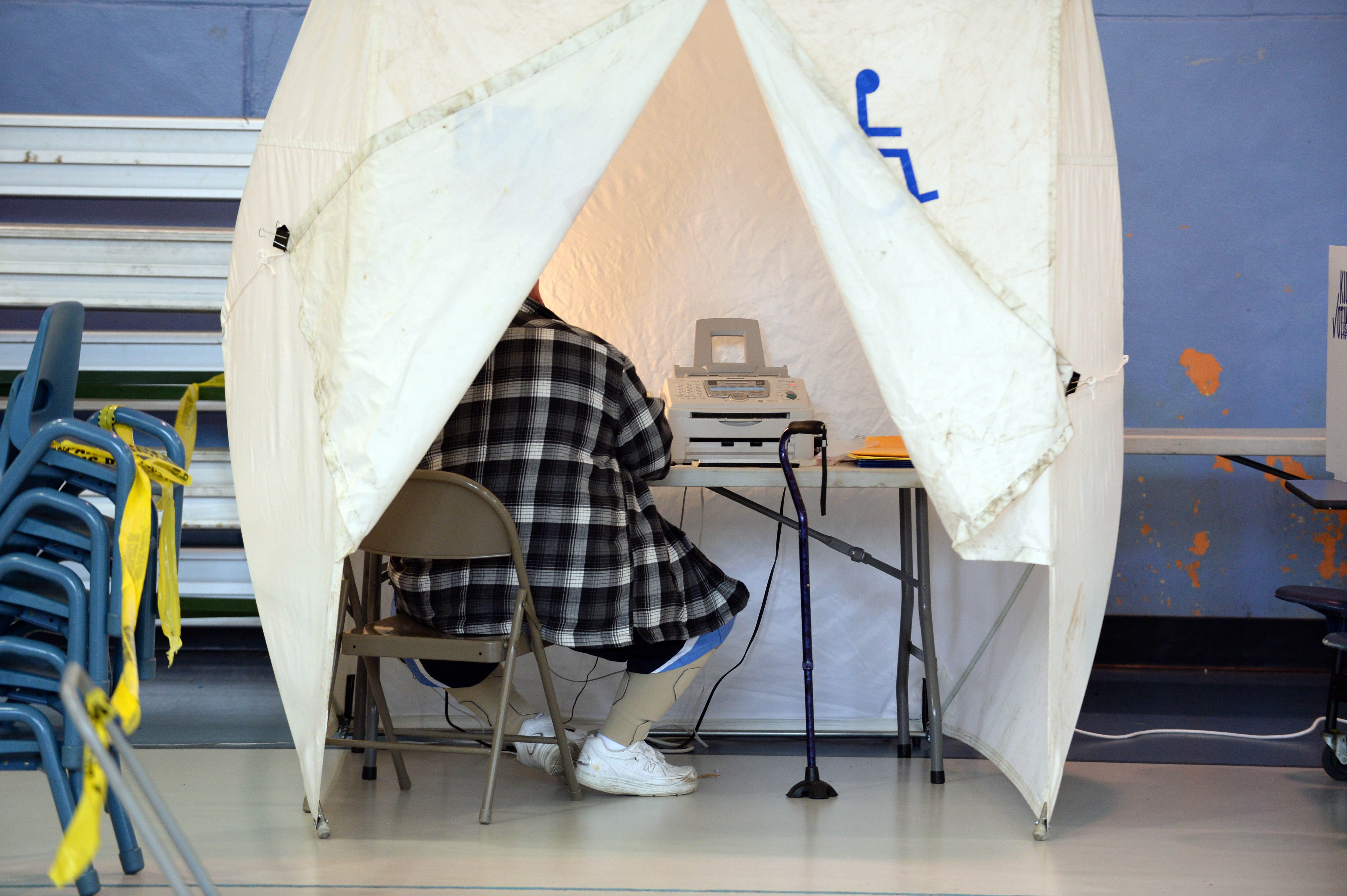 A person votes in the handicapped assisted booth at Bishop Leo E. O'Neil Youth Center November 4, 2014 in Manchester, New Hampshire. CREDIT: Darren McCollester/Getty Images