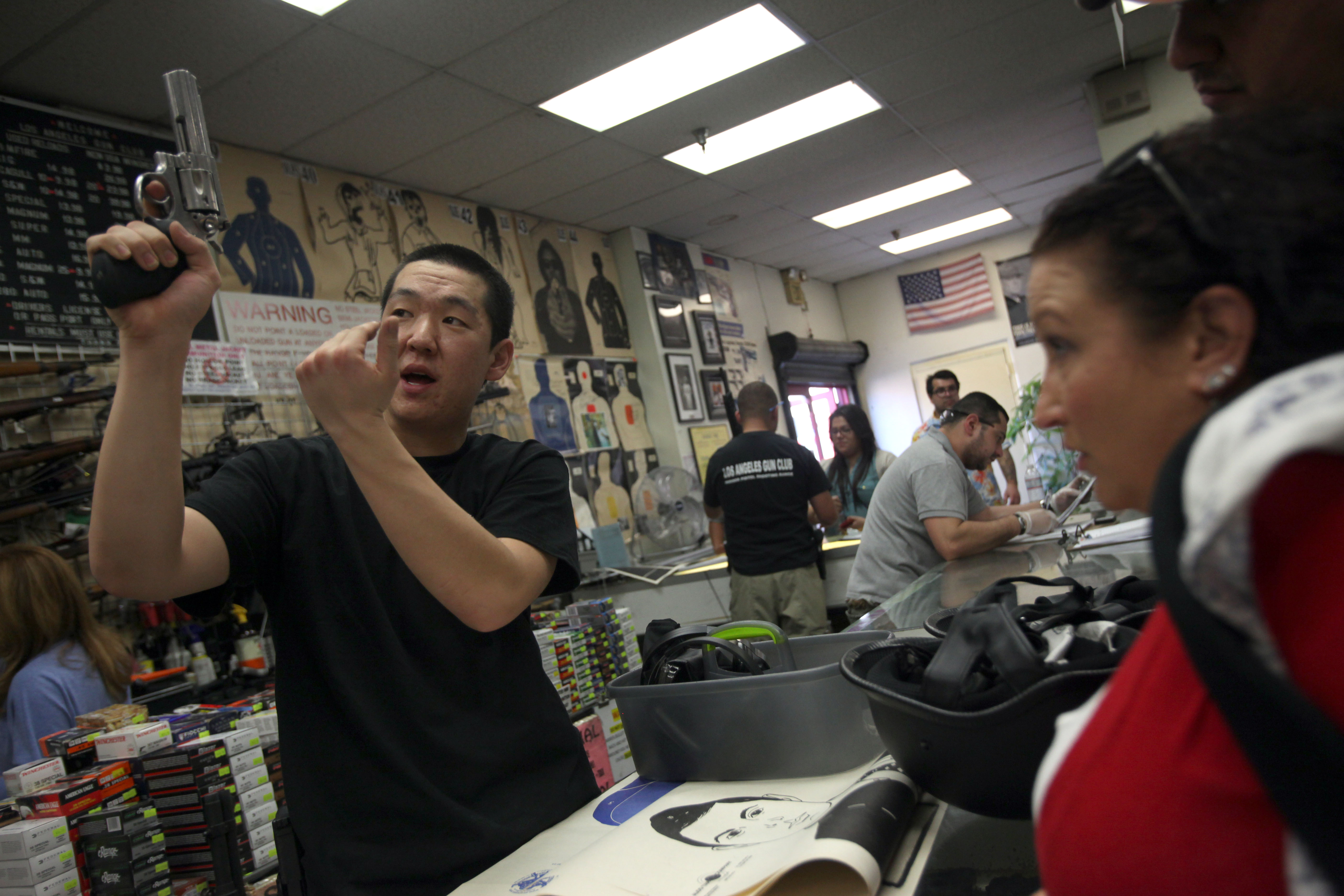 Los Angeles, CA January 19, 2013 In response to gun control measures taken by President Barack Obama, gun advocates held a nationwide "Gun Appreciation Day" Saturday. Business was brisk at the Los Angeles Gun Club but according to employee Joseph Im(cq) the club is busy every weekend. Im, left, shows the workings of a revolver to Tamara Vravis(cq) prior to Vravis going into the shooting range. (Photo by Michael Robinson Chavez/Los Angeles Times via Getty Images)