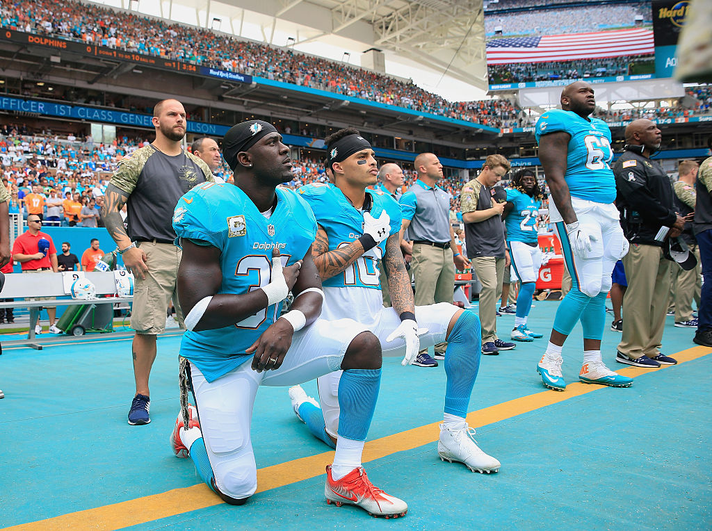Michael Thomas #31 of the Miami Dolphins and Kenny Stills #10 of the Miami Dolphins take a knee during the national anthem prior to the game against the New York Jets at the Hard Rock Stadium on November 6, 2016 in Miami Gardens, Florida. (CREDIT: Chris Trotman/Getty Images)