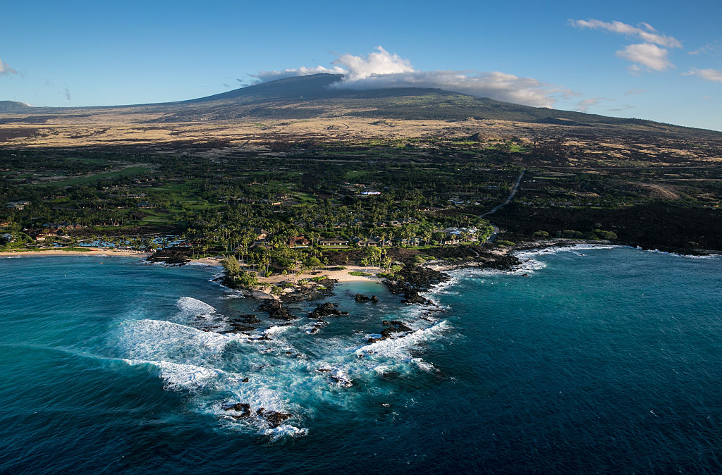 Ocean front condominums and luxury homes are built at the ocean's edge on an old Mauna Loa lava flow as viewed on December 16, 2016, in this aerial photo taken along the Kona Kohala Coast, Hawaii. CREDIT: George Rose/Getty Images