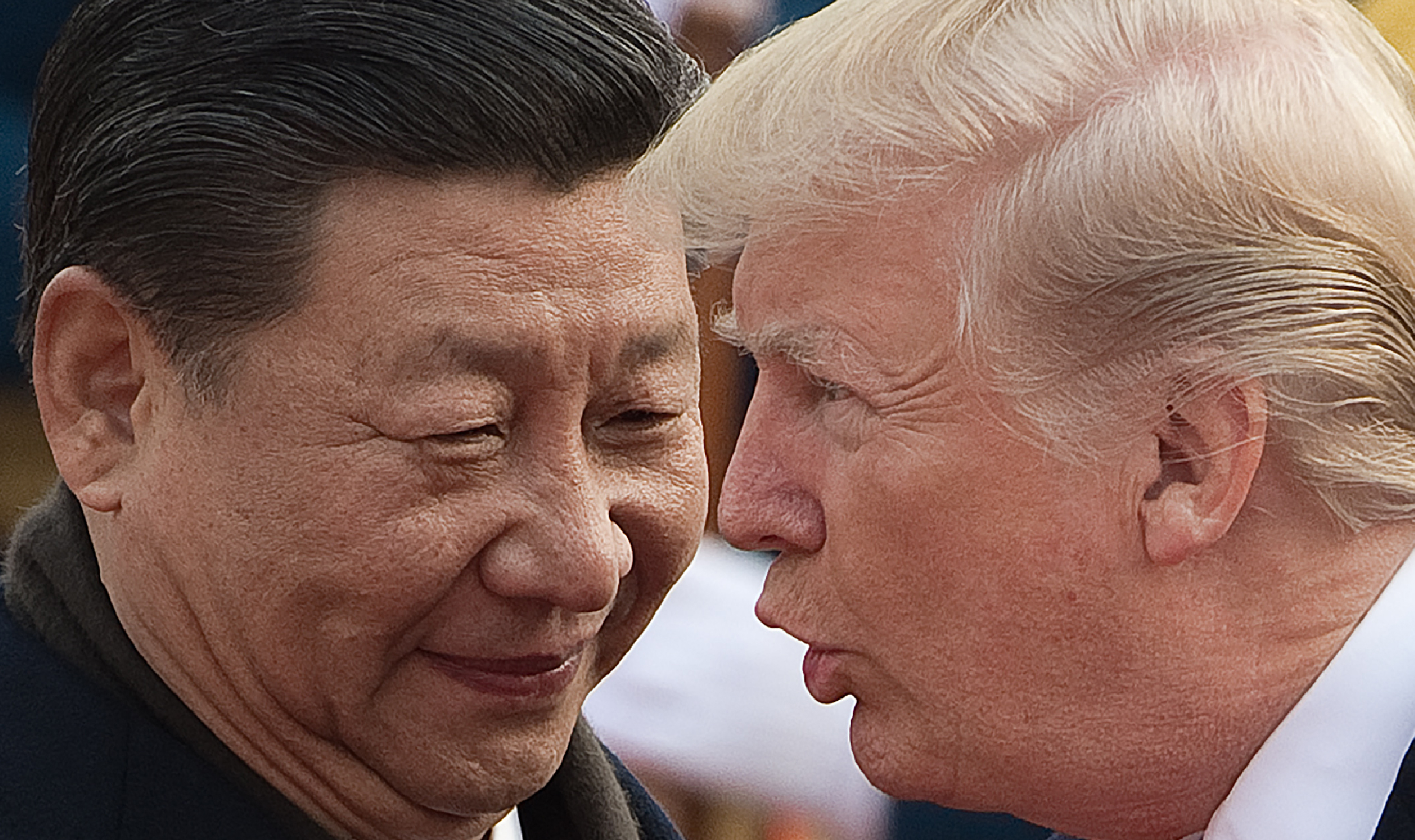 China's President Xi Jinping and President Donald Trump attend a welcome ceremony at the Great Hall of the People in Beijing on November 9, 2017. CREDIT: Nicolas Asfouri/AFP/Getty Images.