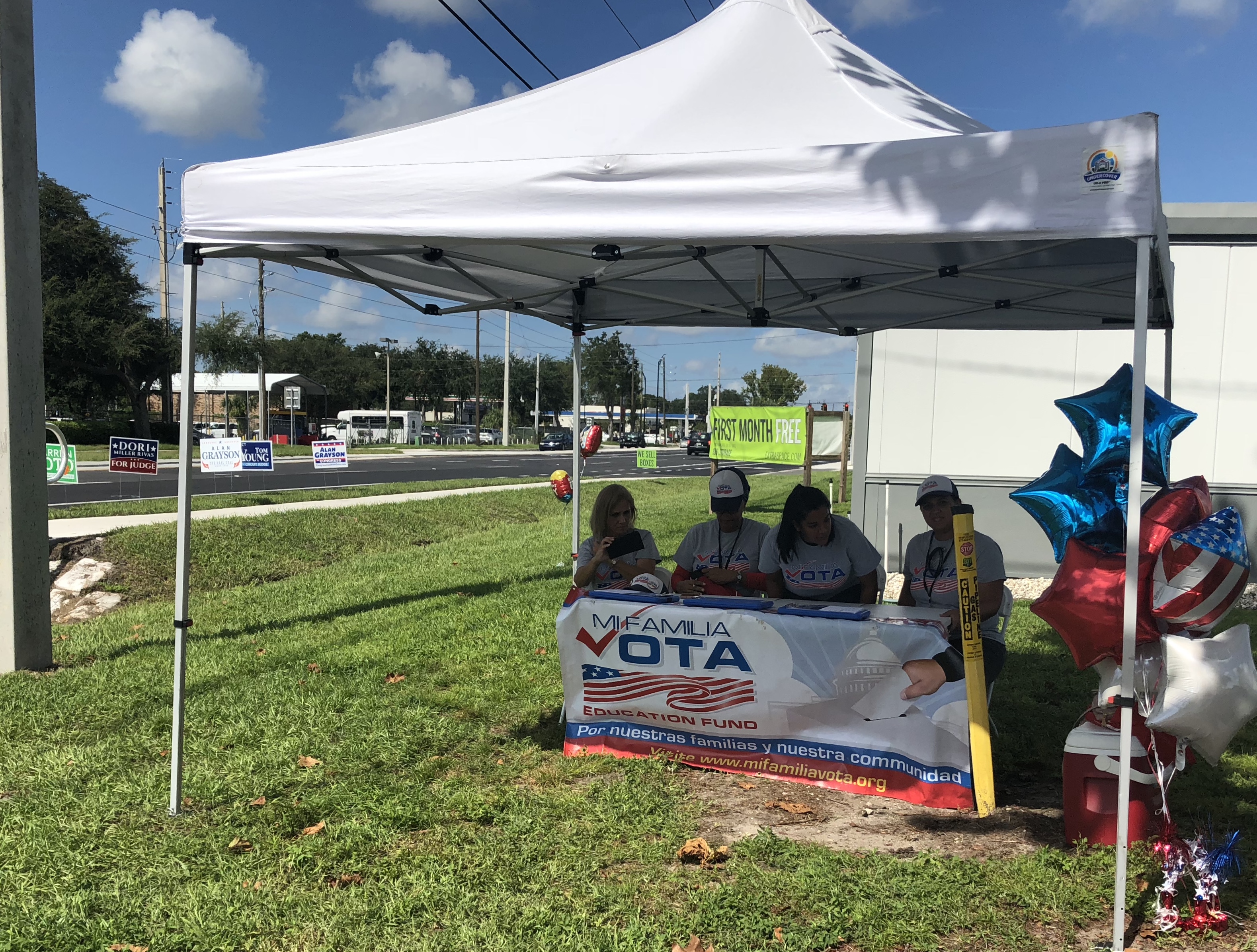 Volunteers with Mi Familia Vota assist voters outside an early voting center in Orlando on Sunday. CREDIT: Kira Lerner
