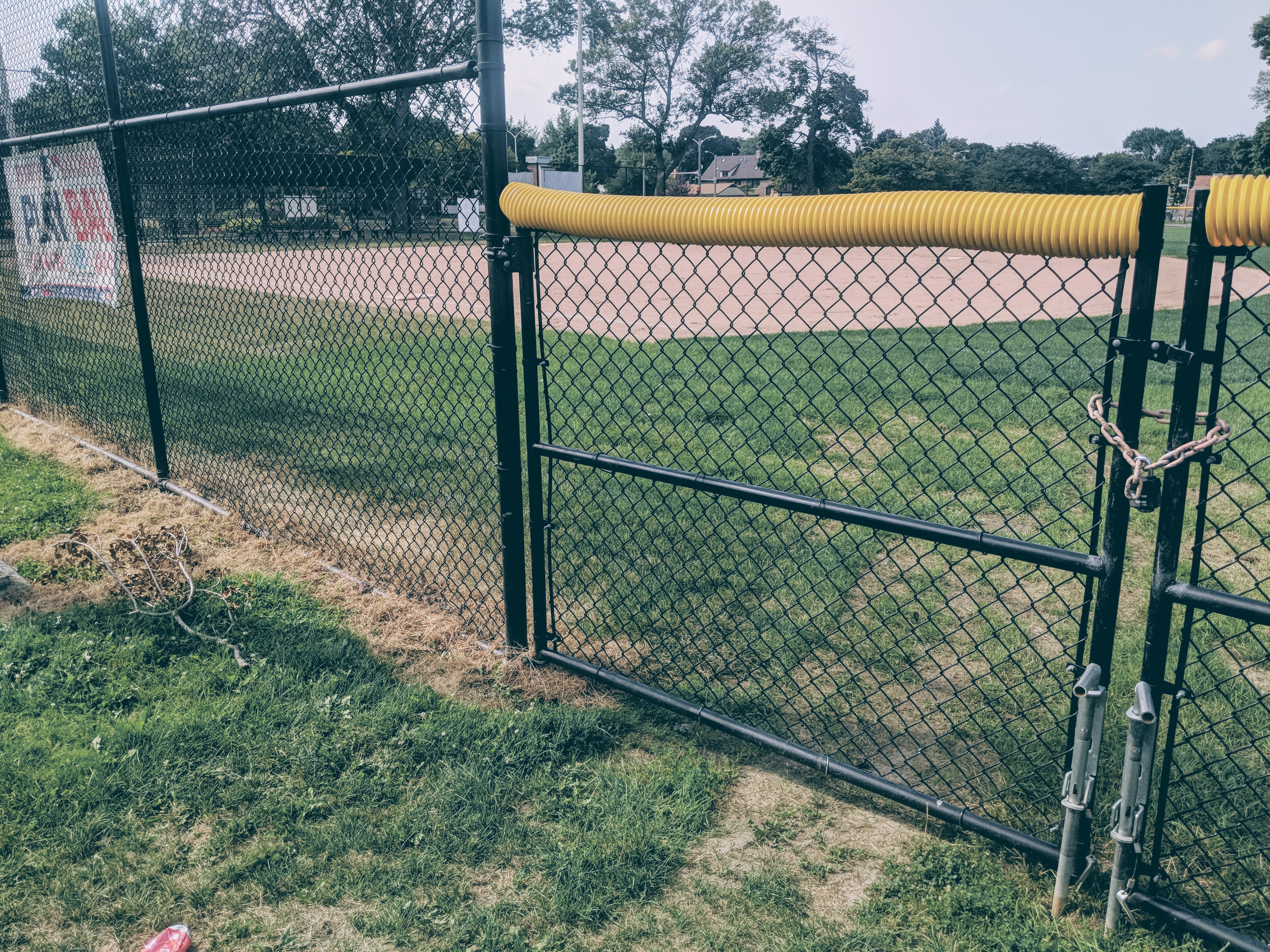 A sign for the MLB's "Play Ball" youth program on the facade of a ballfield in Sherman Park. The field stays locked to the kids who can't afford memberships to the local Boys & Girls Club. CREDIT: Alan Pyke/ThinkProgress