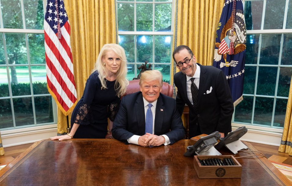 President Donald Trump poses with QAnon conspiracy theorists. (Twitter/@LionelMedia)