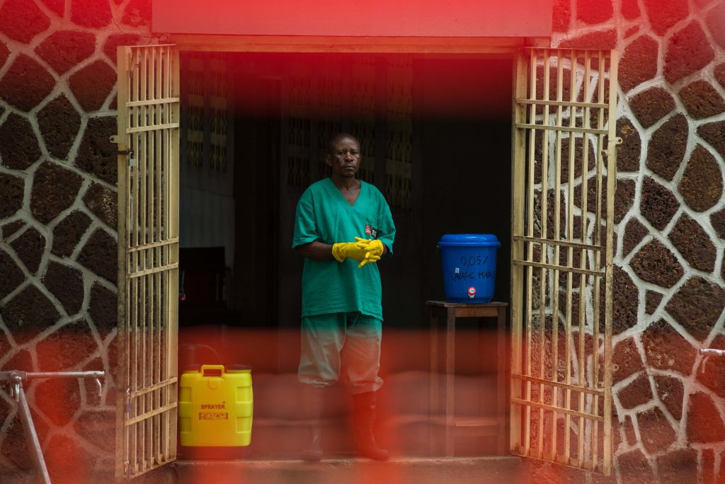 One week after the Democratic Republic of Congo declared a deadly Ebola virus outbreak over, the governor of the country's northeastern North Kivu province says the country may be facing yet another potential EVD epidemic.
ABOVE: An attendant stands at the entrance of the Wangata Reference Hospital in Mbandaka on May 20, 2018. (Photo credit: JUNIOR KANNAH/AFP/Getty Images)