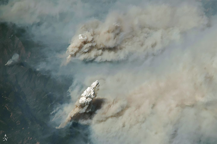 Massive smoke plumes billow out of California's wildfires. (Credit: NASA Earth Observatory)