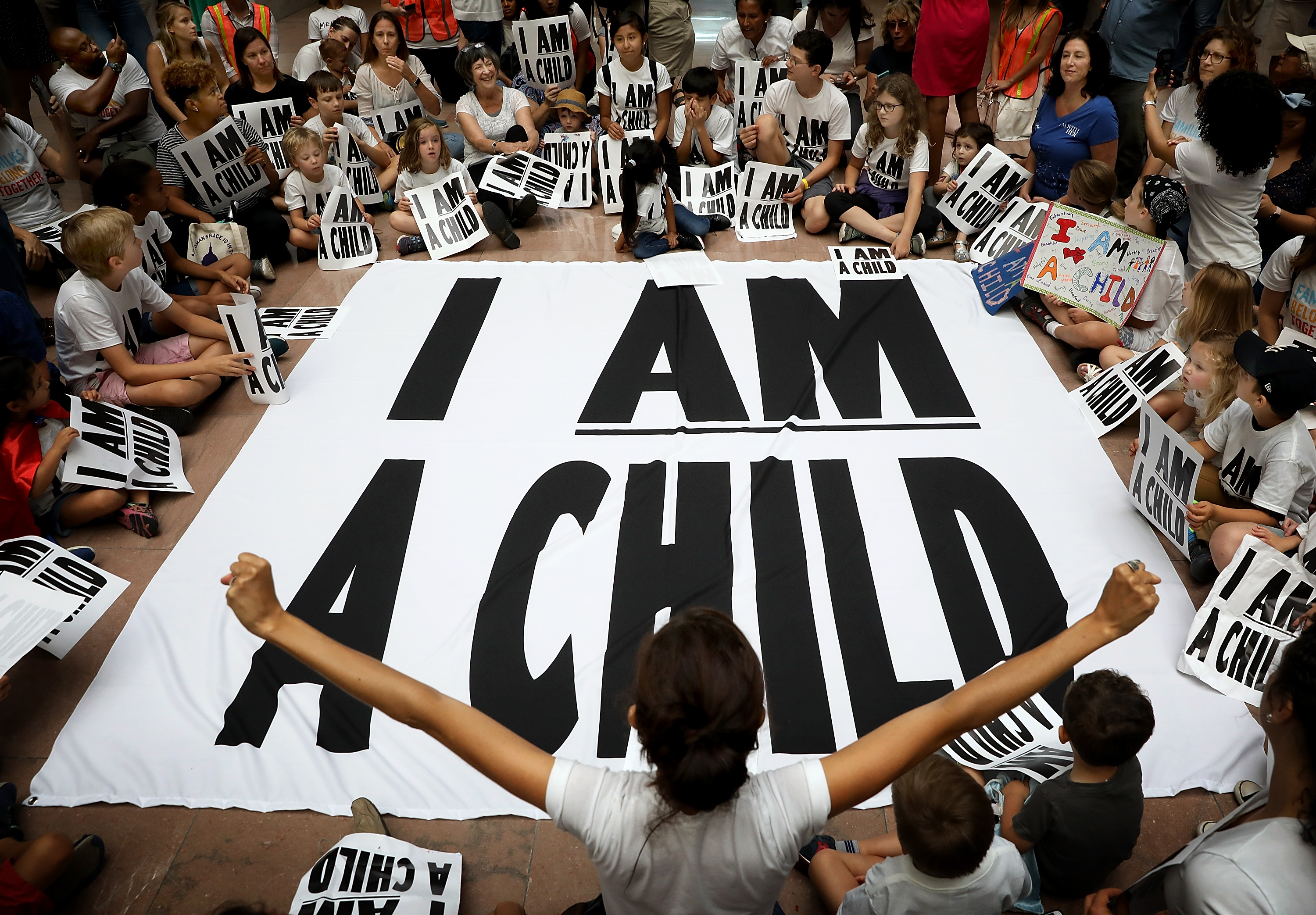 Protesters and their children participate in a sit-in in the Hart Senate Office Building to mark the court-ordered deadline for the Trump Administration to reunify thousands of families separated at the border July 26, 2018 in Washington, DC. (Photo Credit: Win McNamee/Getty Images)