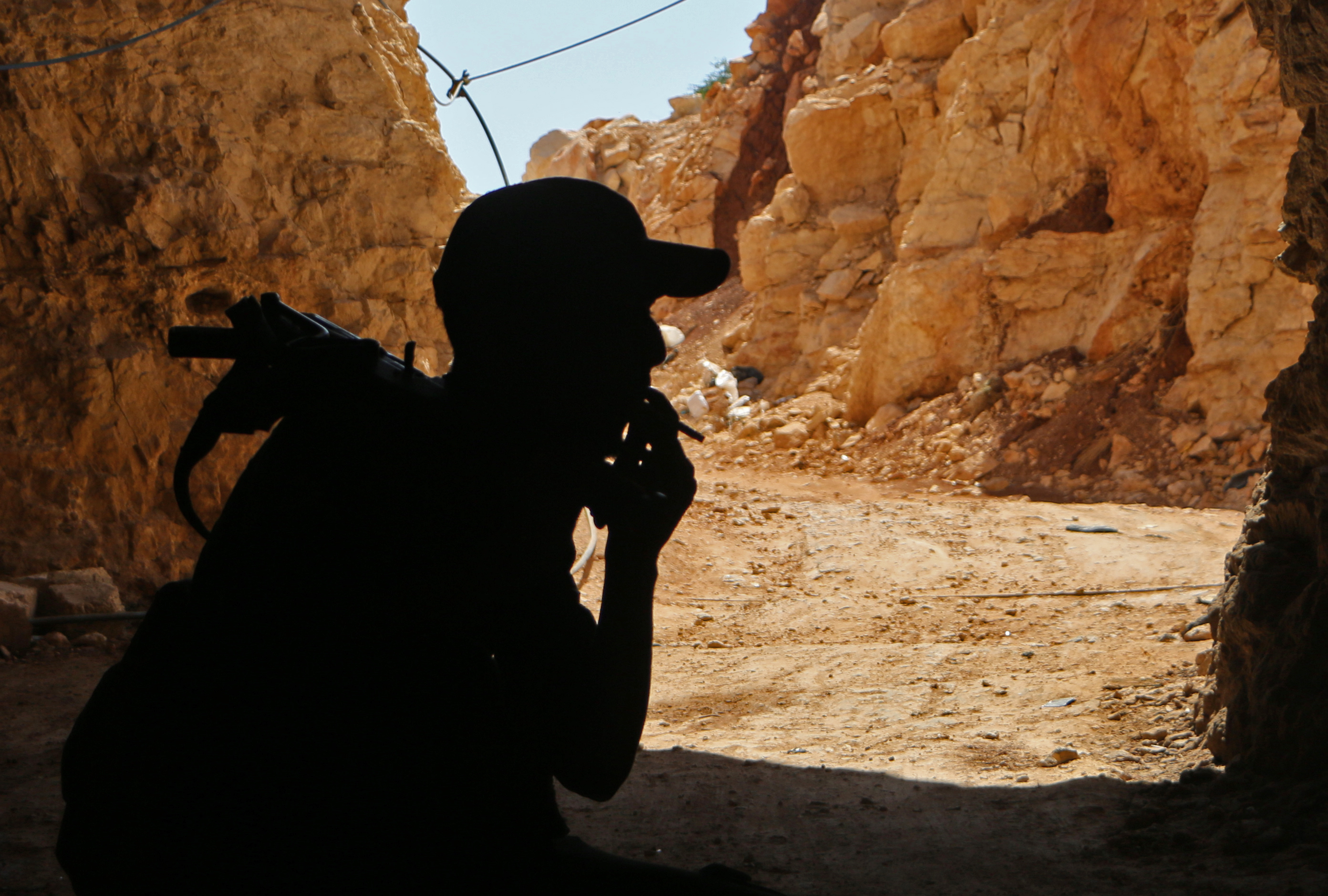 A Syrian rebel fighter from the recently-formed "National Liberation Front" smokes a cigarette at an unknown location in the Idlib province on September 5, 2018. CREDIT: Aaref Watad/AFP/ Getty Images.