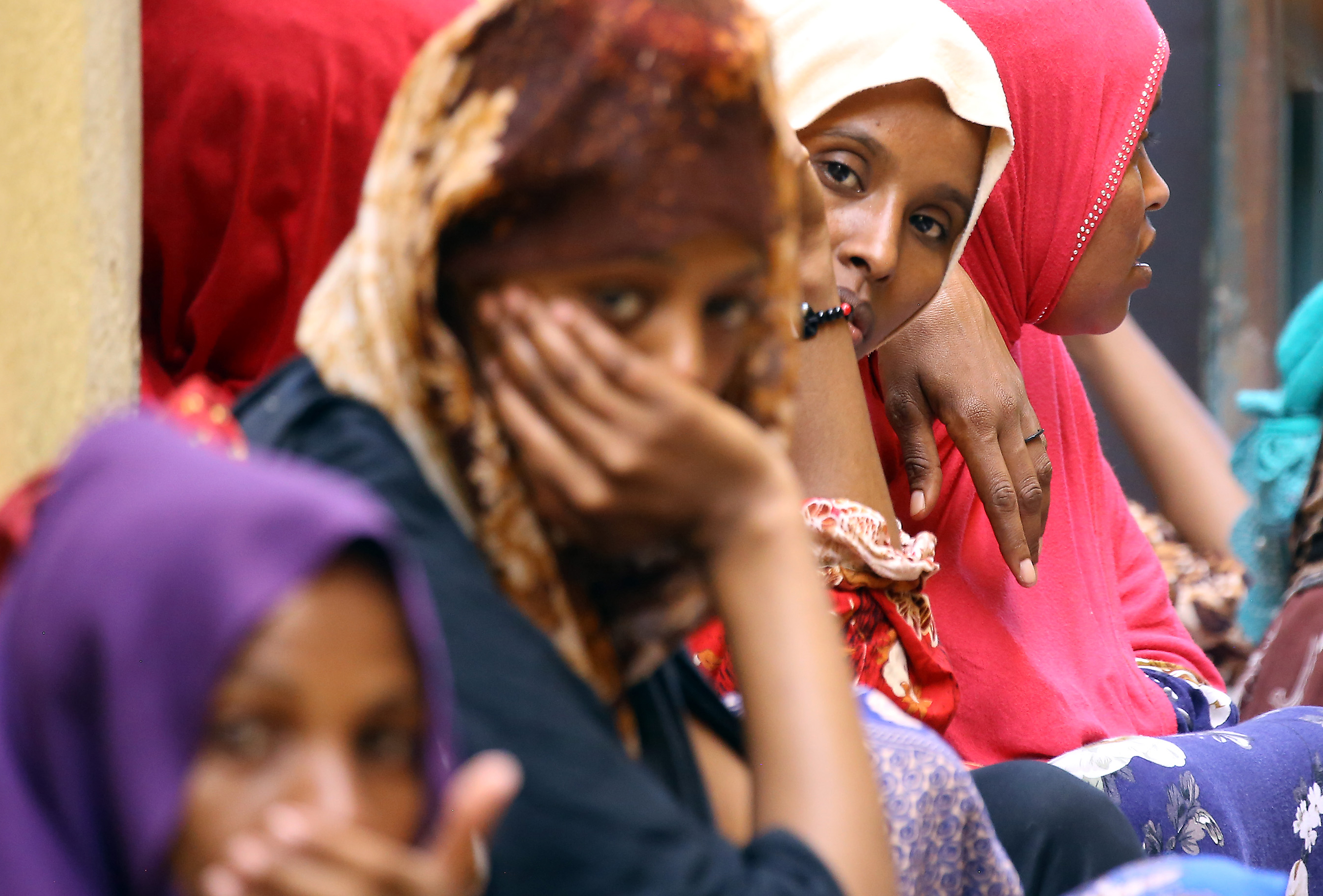 Migrants sit inside the Ganzour shelter after being transferred from in the airport road due to fighting in the Libyan capital Tripoli on September 5, 2018. CREDIT: Mahmud Turkia/AFP/Getty Images.
