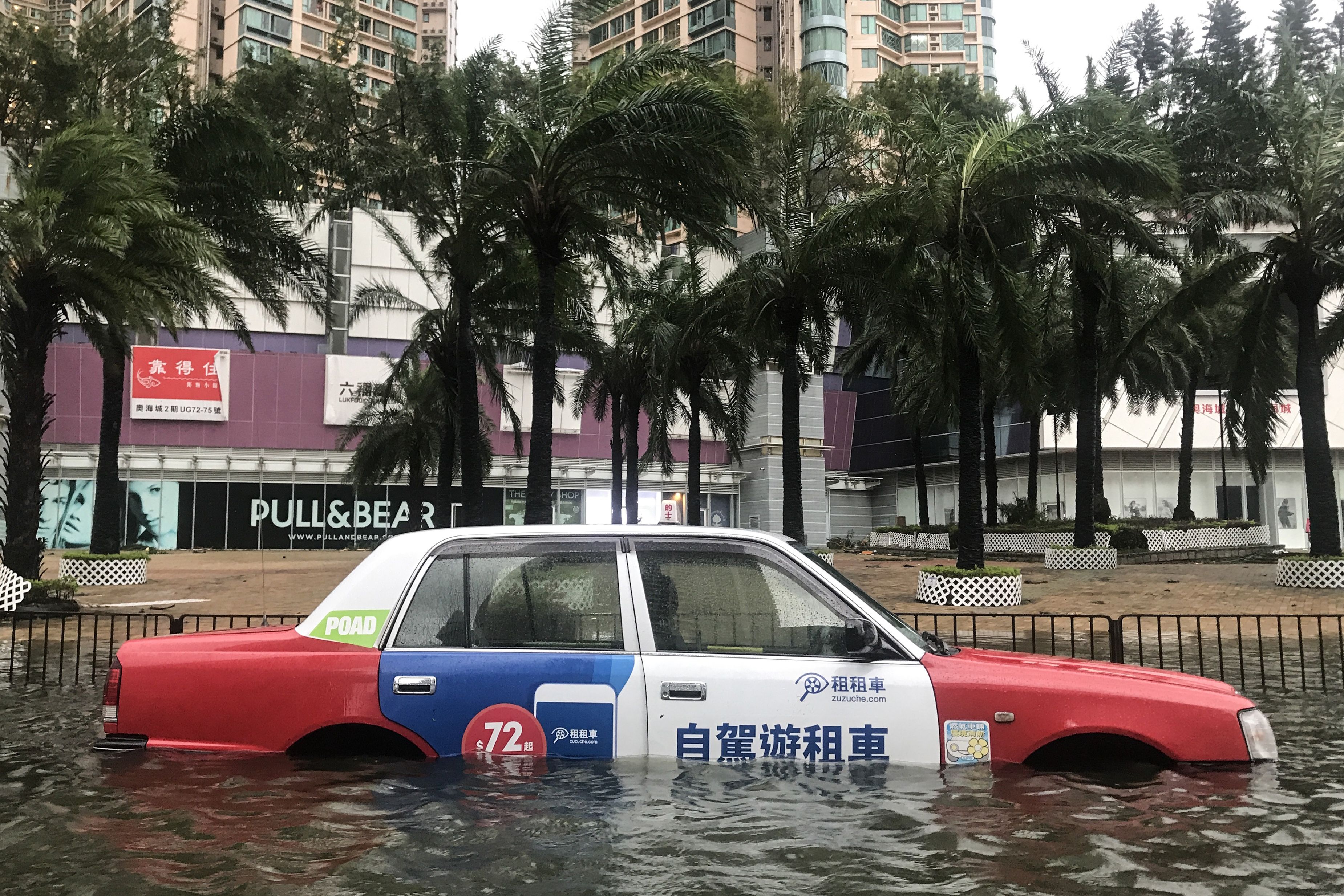 A taxi is left abandoned after breaking down in floodwaters during Super Typhoon Mangkhut in Hong Kong on September 16, 2018. CREDIT: ANTHONY WALLACE/AFP/Getty Images