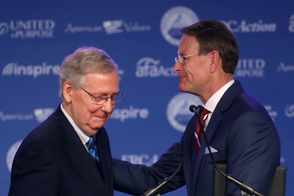 Senate Majority Leader Mitch McConnell (R-KY) is welcomed to the stage by Family Research Council President Tony Perkins during the Value Voters Summit, September 21, 2018 in Washington, D.C. McConnell promised attendees that Supreme Court nominee Brett Kavanaugh, who is currently facing allegations of sexual assault, will be appointed to the Court in "the very near future." (Photo credit: Chip Somodevilla/Getty Images)