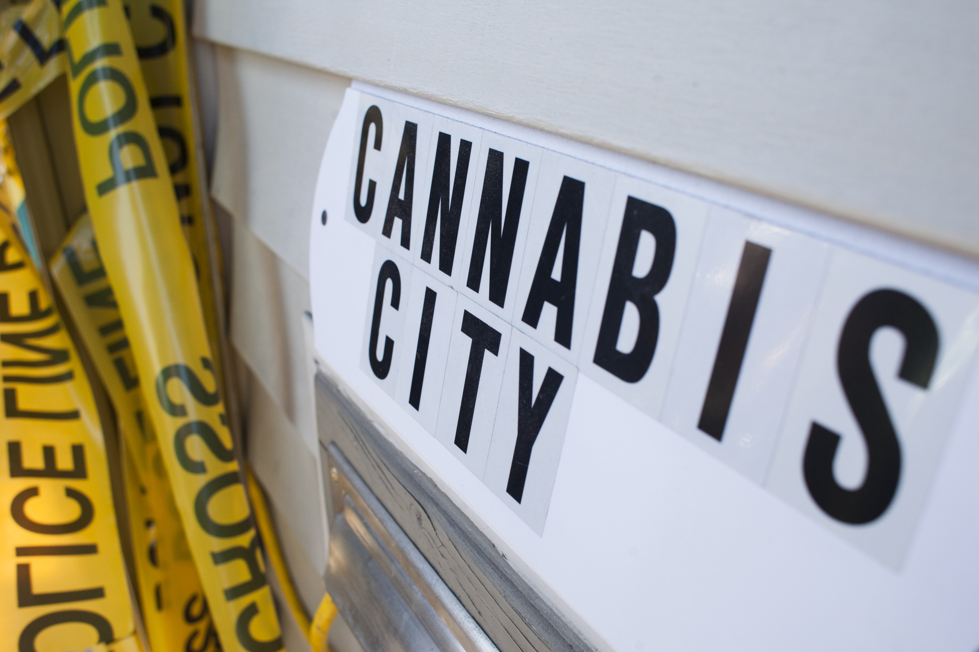SEATTLE, WA - JULY 8: A sign is pictured near police tape, which was used as a prop for a ribbon cutting ceremony, at Cannabis City, a retail marijuana store, on July 8, 2014 in Seattle, Washington. Cannabis City was the first retail marijuana store to open in Seattle. (Photo by David Ryder/Getty Images)