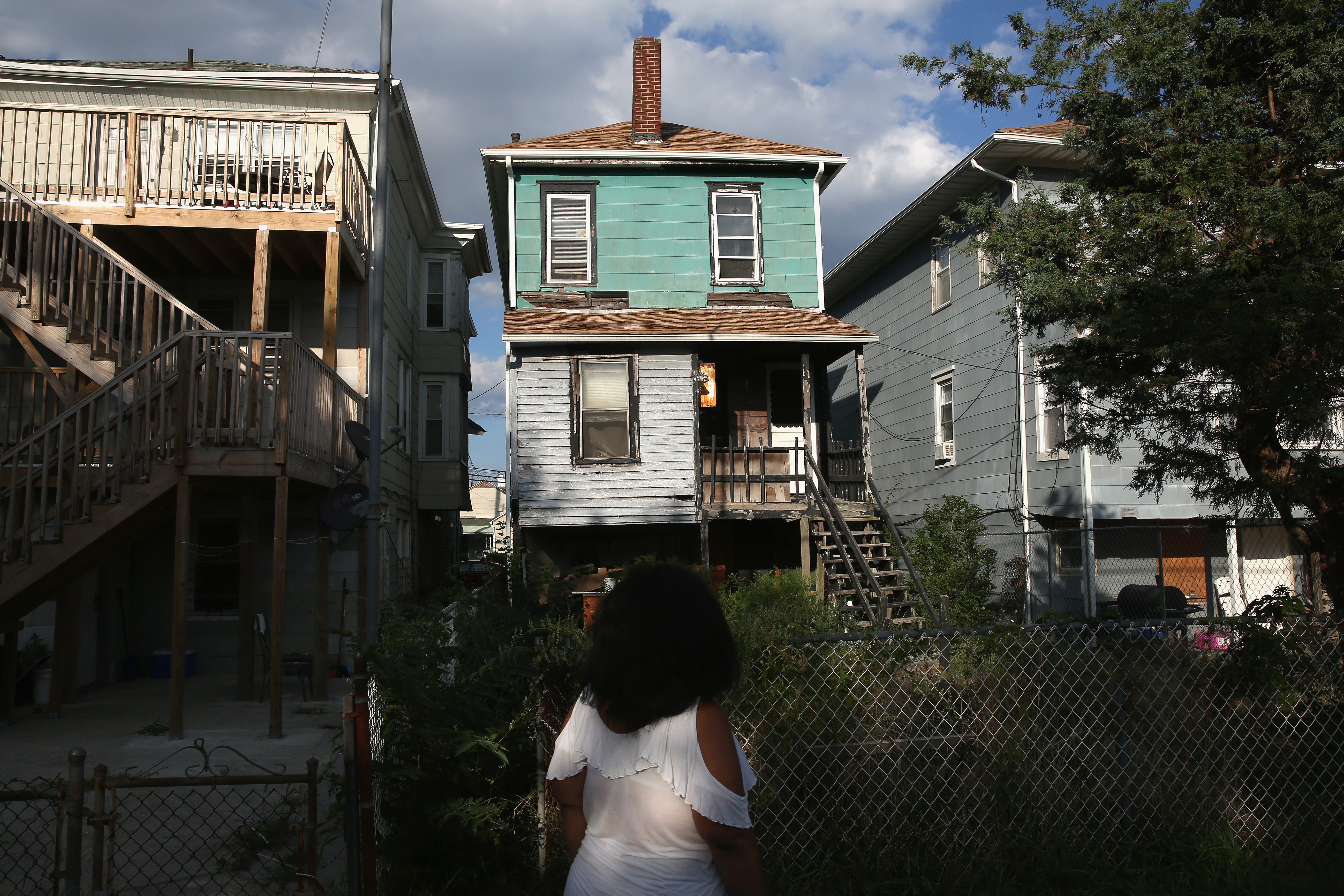 An Atlantic City, NJ resident walks through an impoverished neighborhood. CREDIT: John Moore/Getty Images