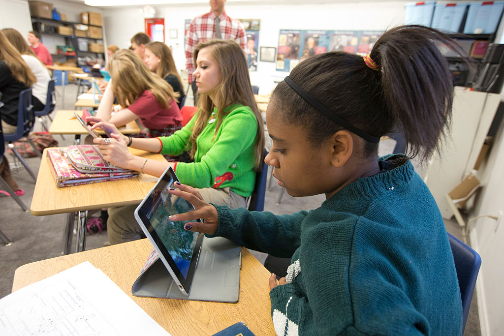High school freshmen and sophomore students at Concordia High School using Apple iPads in the world geography classroom at the private religious school outside Austin, Texas. CREDIT: Robert Daemmrich Photography Inc/Corbis via Getty Images