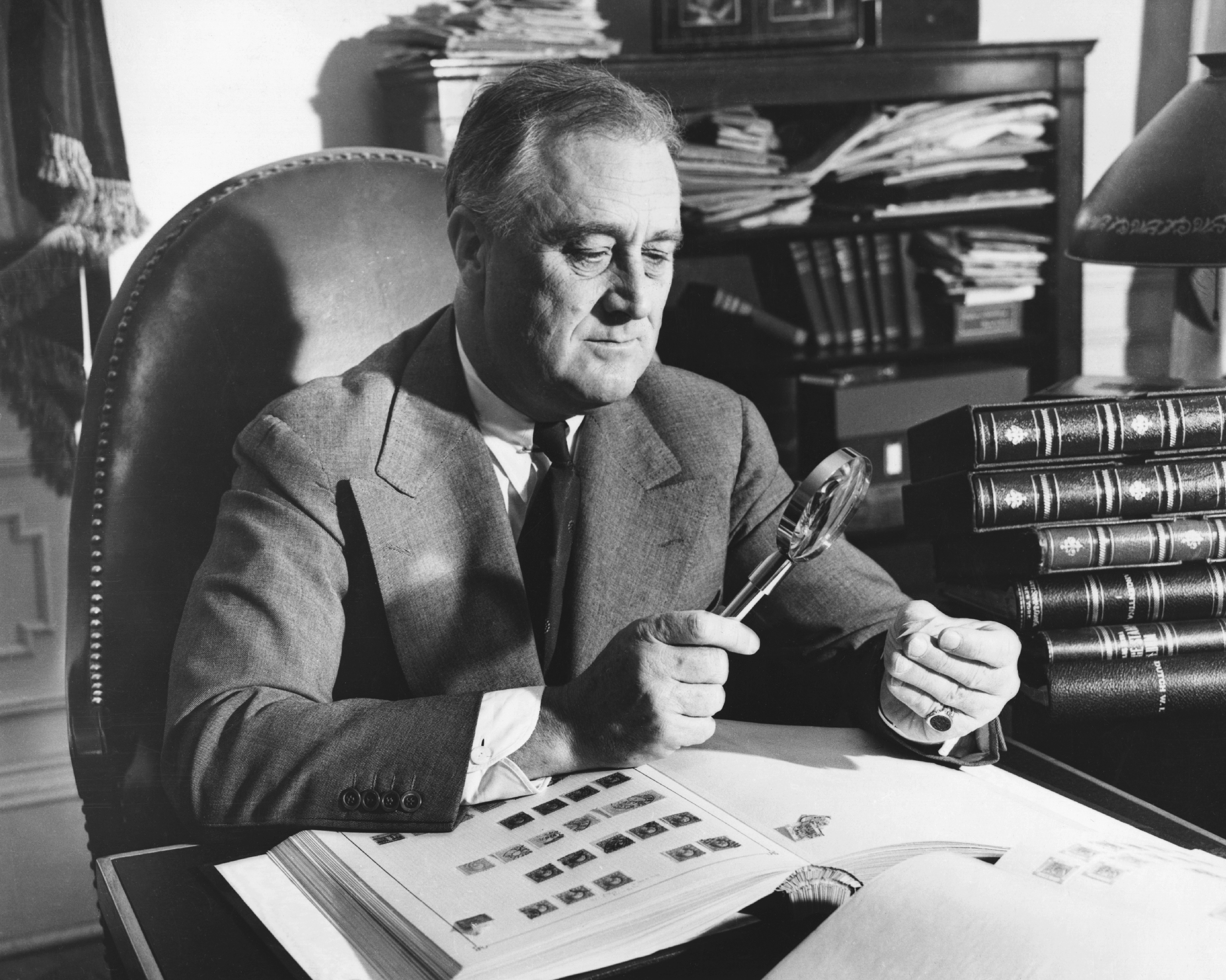 President Franklin Delano Roosevelt, an avid stamp collector and member of the American Philatelic Society, works on his collection in the Oval Office. (Photo by Hulton-Deutsch/Hulton-Deutsch Collection/Corbis via Getty Images)