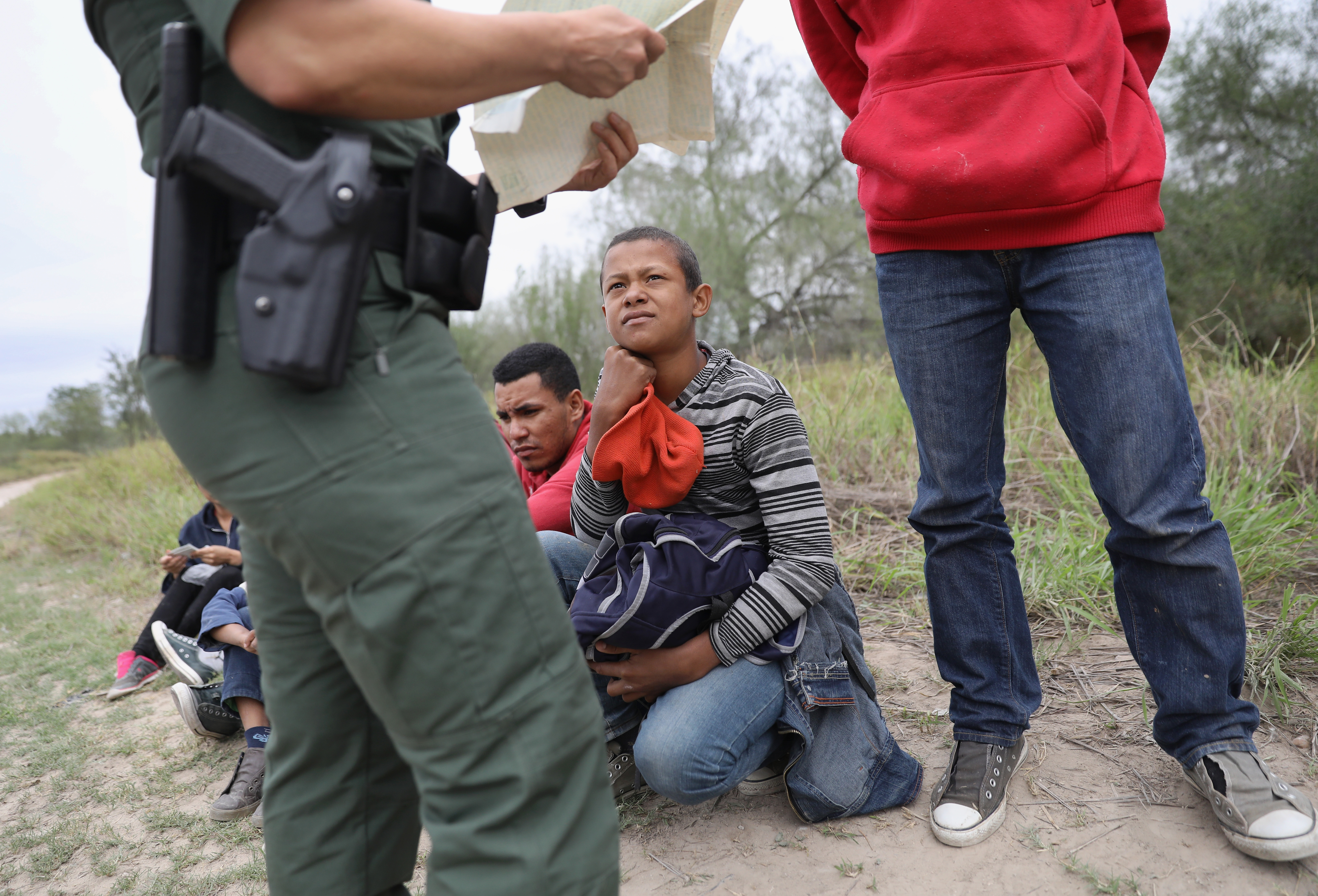 A U.S. Border Patrol agent checks birth certificates while taking Central American immigrants into custody on January 4, 2017 near McAllen, Texas. CREDIT: John Moore/Getty Images