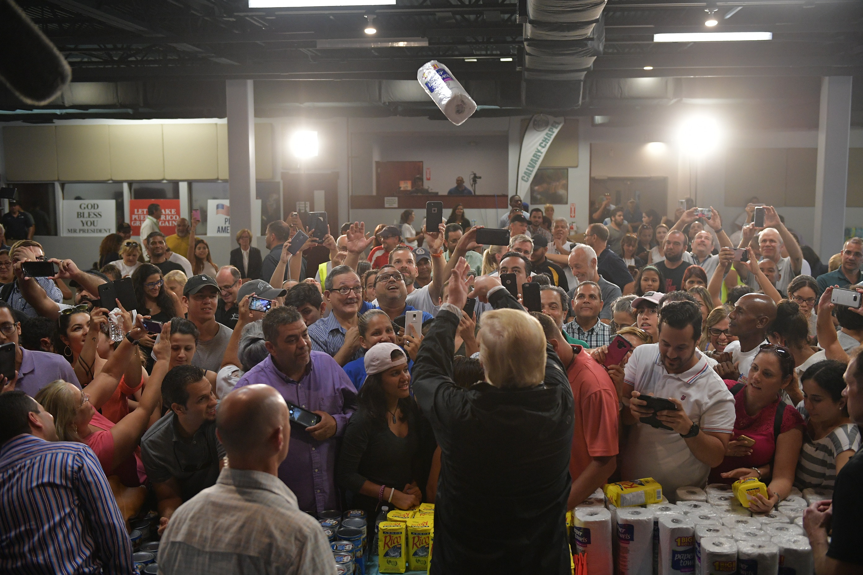 Trump throws a paper towel roll as he visits the Cavalry Chapel in Puerto Rico on October 3, 2017.
(CREDIT: MANDEL NGAN/AFP/Getty Images)