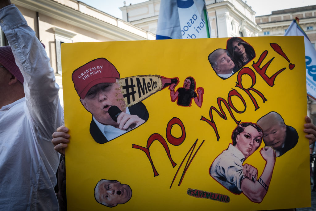 Women demonstrate against sexual harassment, violence and President Donald Trump,.