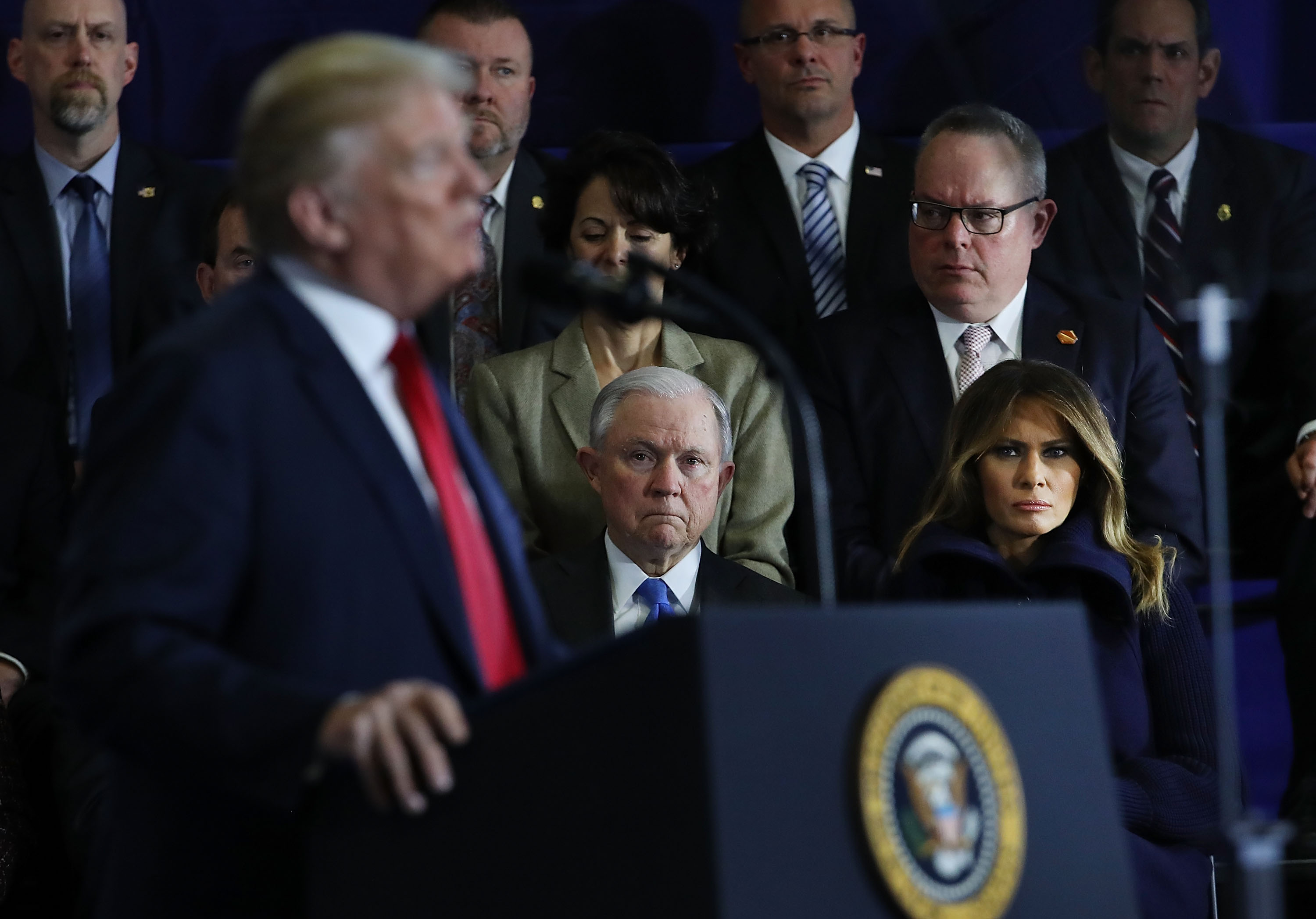 U.S. Attorney General Jeff Sessions listens as President Donald Trump addresses supporters in New Hampshire. CREDIT: Spencer Platt/Getty Images