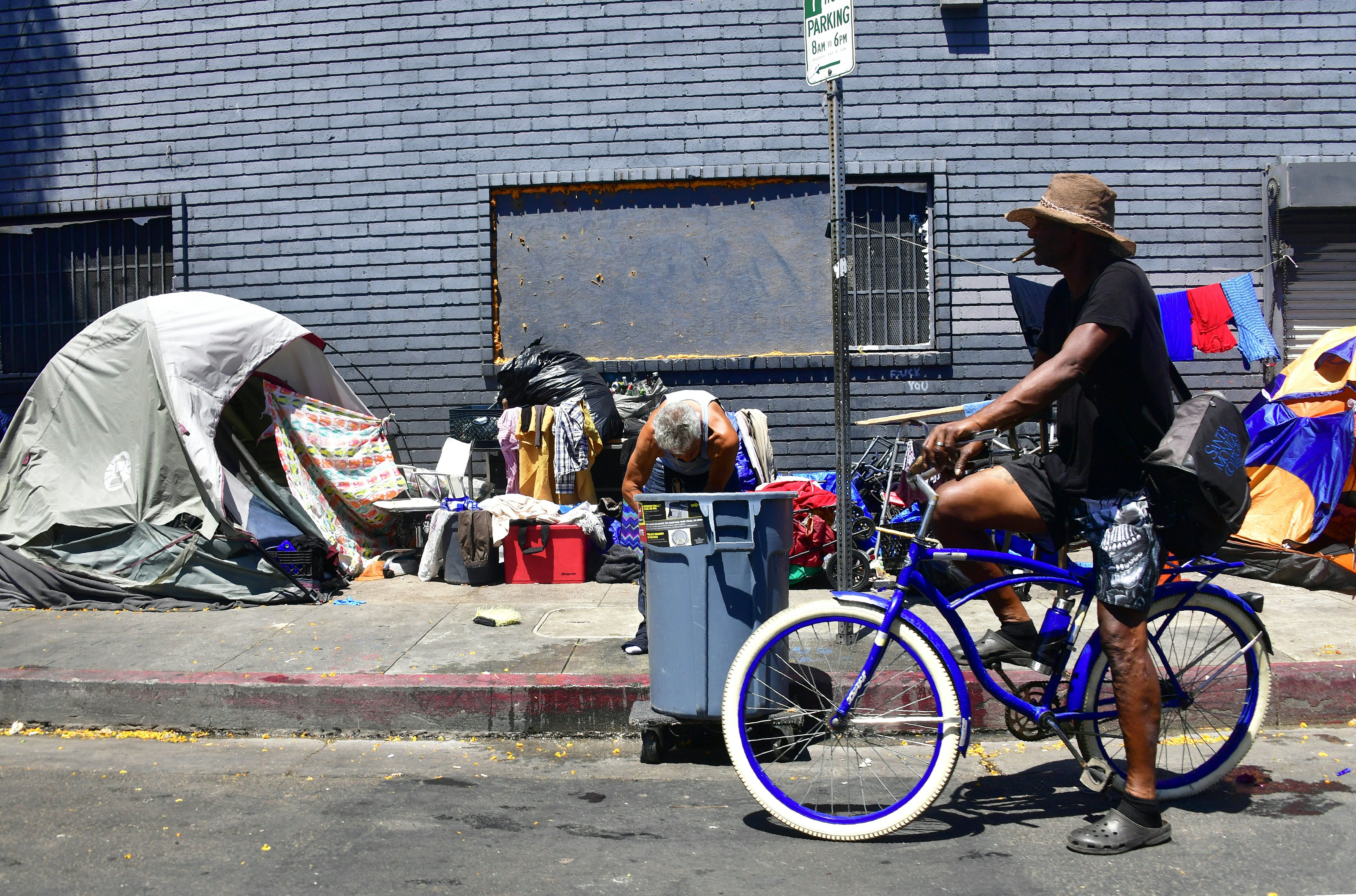 Tents and belongings of the homeless line a street in downtown Los Angeles, California on June 25, 2018, as a United Nations report on poverty and inequality says 185 million Americans are living in extreme poverty. (Photo by Frederic J. BROWN / AFP) (Photo credit should read FREDERIC J. BROWN/AFP/Getty Images)