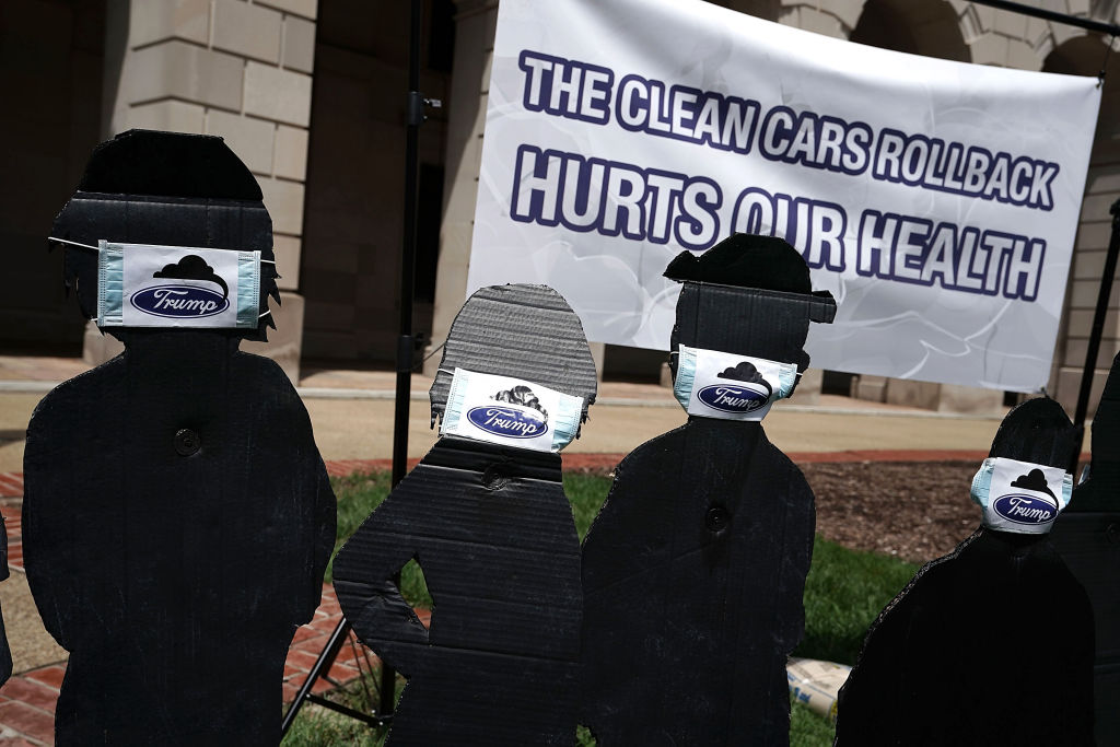 Cardboard cutouts of children wearing surgical masks are seen during a protest outside EPA headquarters on August 2, 2018 in Washington, DC. CREDIT: Alex Wong/Getty Images.