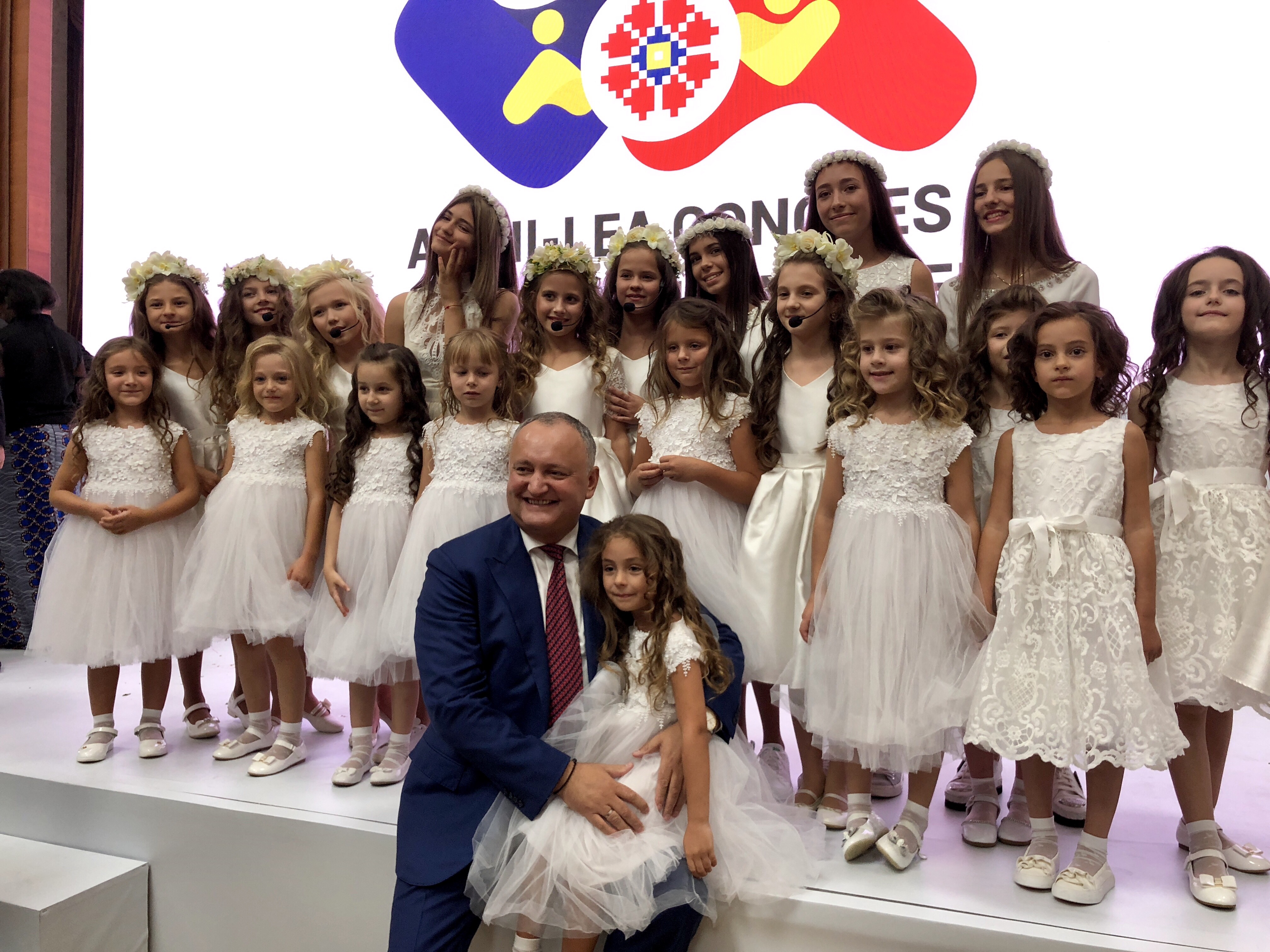 Moldovan President Igor Dodon celebrated the end of the World Congress of Families by posing with two dozen young girls. CREDIT: CASEY MICHEL