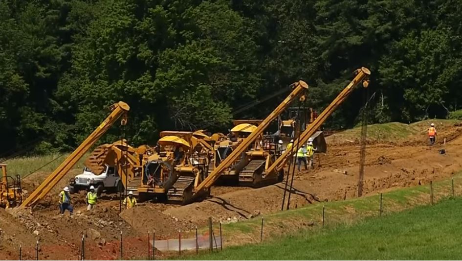 Construction crews work on the Mountain Valley Pipeline in Virginia. CREDIT: Screenshot/WSLS 10