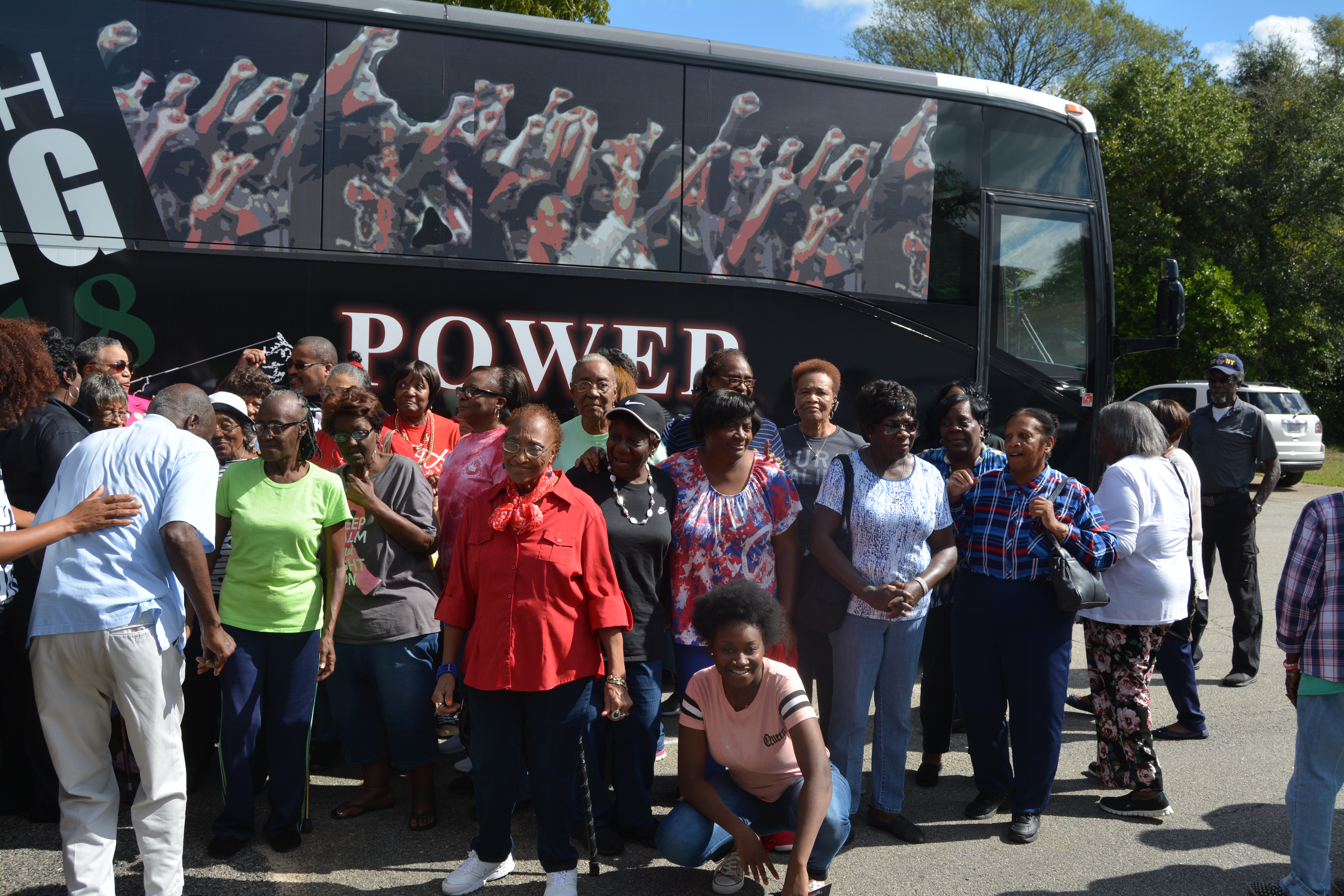 Seniors in Jefferson County pose with Black Voters Matter's bus. CREDIT: Kira Lerner