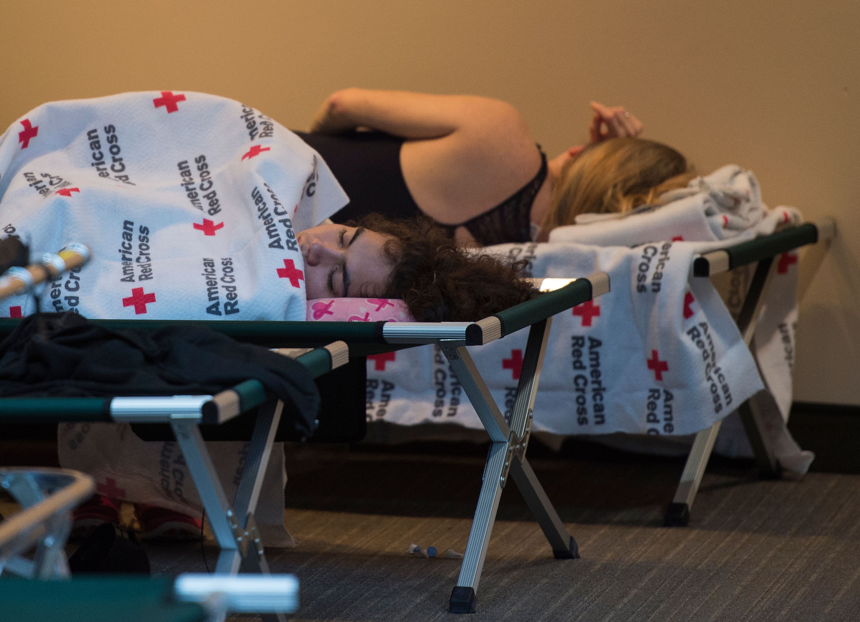 People rest on cots inside an American Red Cross evacuation shelter in Chapel Hill, North Carolina on September 17, 2018. (Credit: ANDREW CABALLERO-REYNOLDS/AFP/Getty Images)