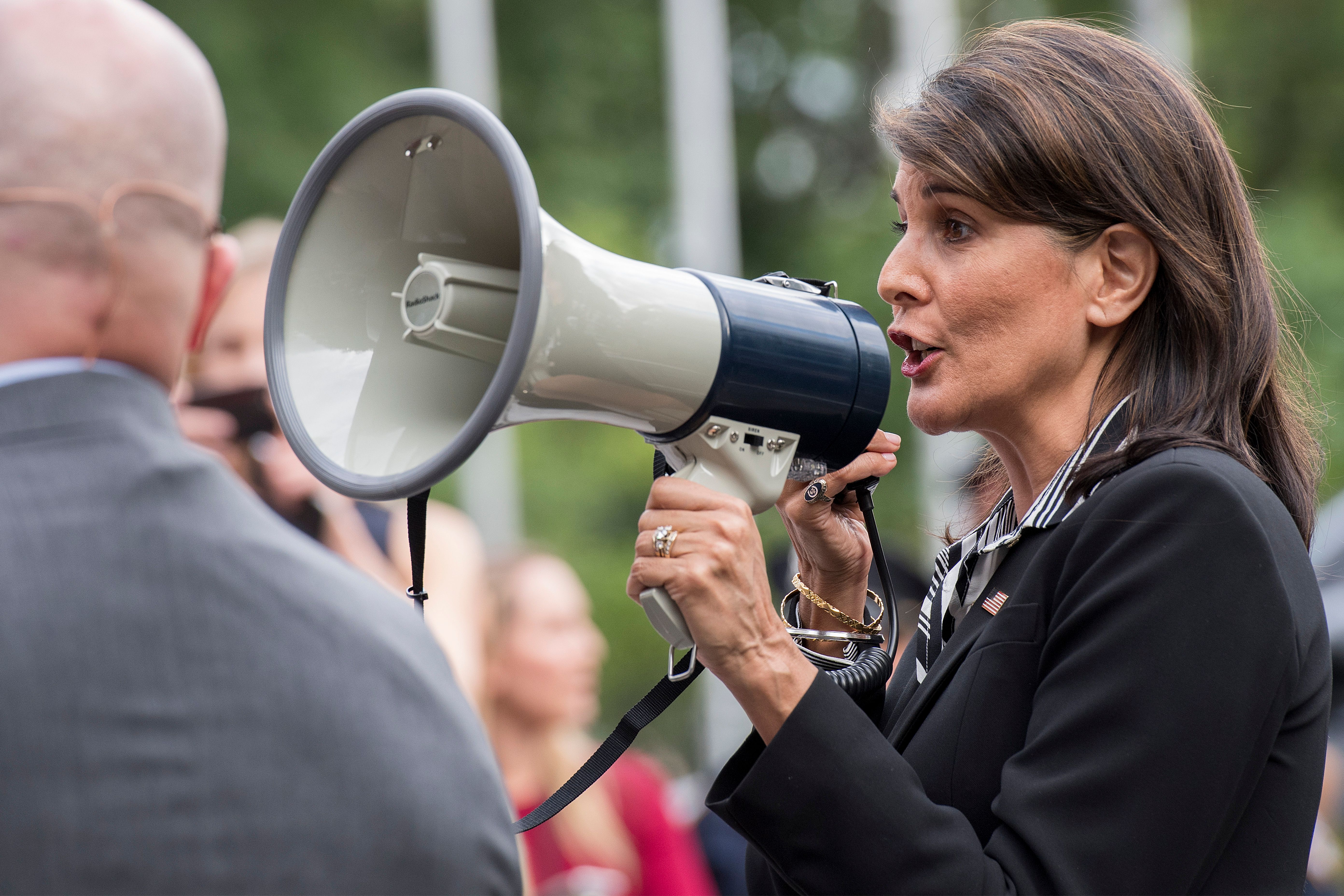 US Ambassador to the United Nations Nikki Haley speaks to Venezuelan demonstrastors using a loud speaker as they protest embattled Venezuelan President Nicolas Maduro outside the United Nations headquarters in New York on September 27, 2018. CREDIT: Jim WATSON / AFP/Getty Images.