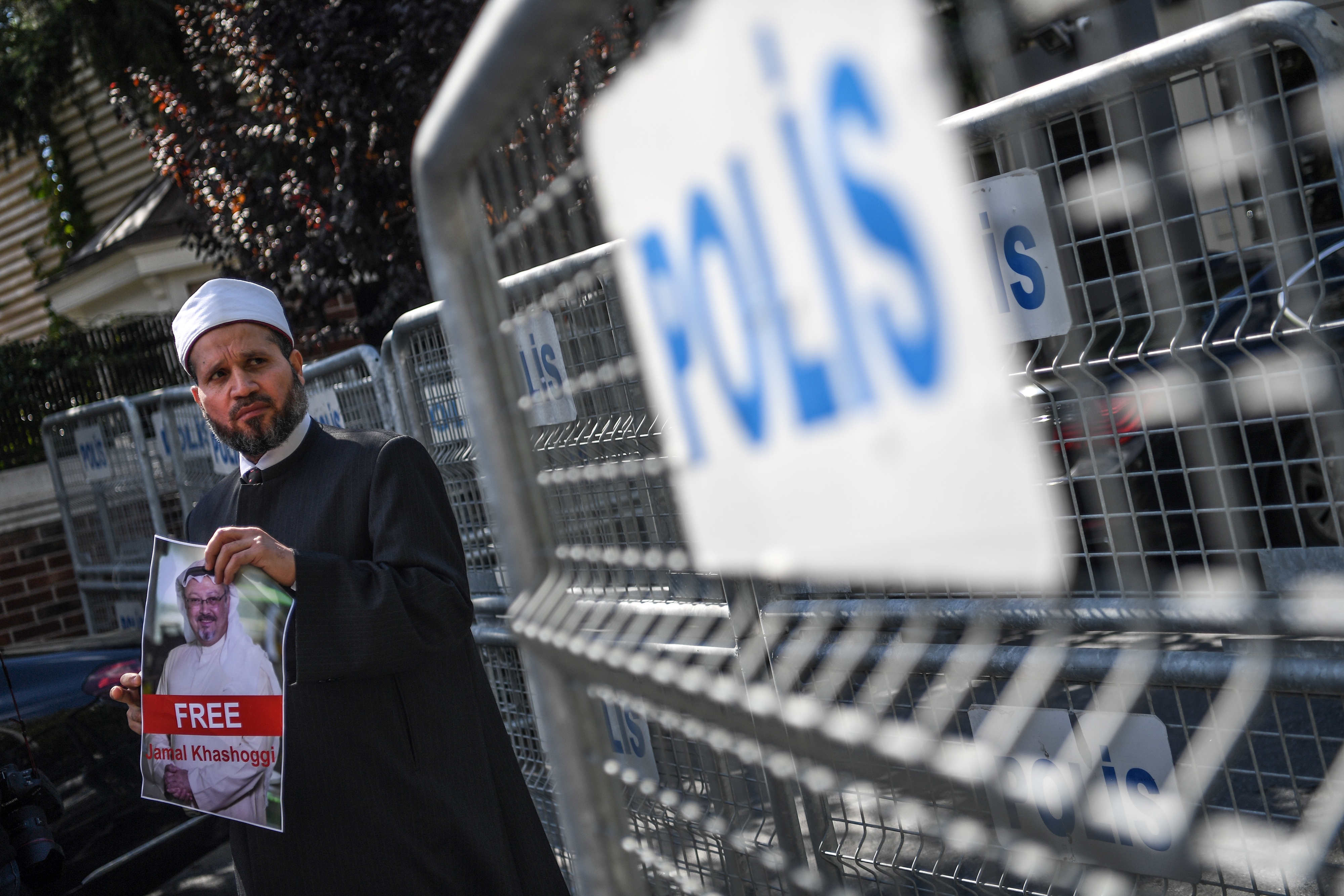 A protestor holds a picture of missing journalist Jamal Khashoggi during a demonstration in front of the Saudi Arabian consulate in Istanbul, Turkey on Oct. 5, 2018. CREDIT: OZAN KOSE/AFP/Getty Images