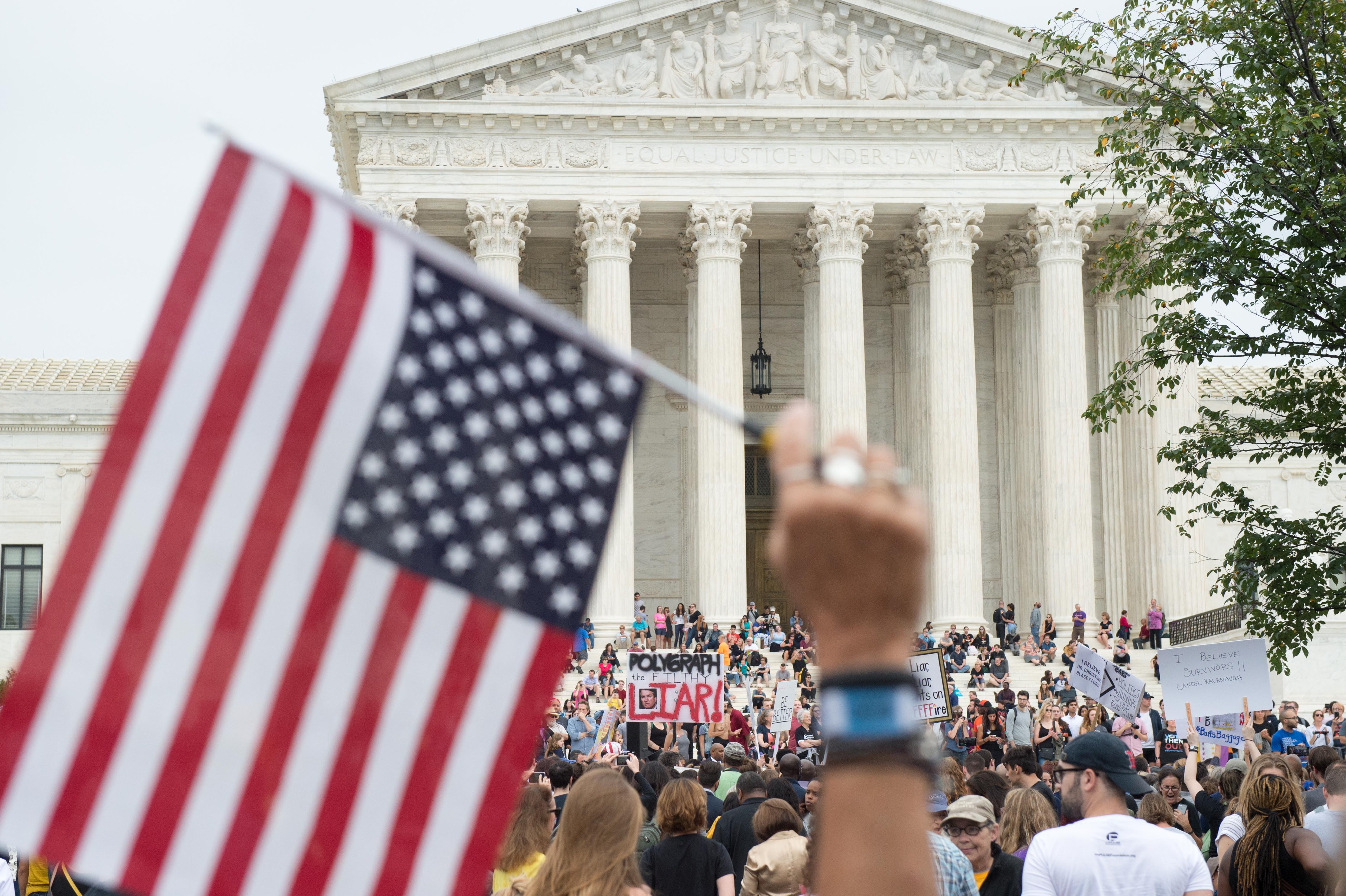 Demonstrators protest against the appointment of Supreme Court nominee Brett Kavanaugh at the Supreme Court in Washington DC, on October 6, 2018. - The US Senate confirmed conservative judge Kavanaugh as the next Supreme Court justice on October 6, offering US President Donald Trump a big political win and tilting the nation's high court decidedly to the right. (Photo by ROBERTO SCHMIDT / AFP) (Photo credit should read ROBERTO SCHMIDT/AFP/Getty Images)