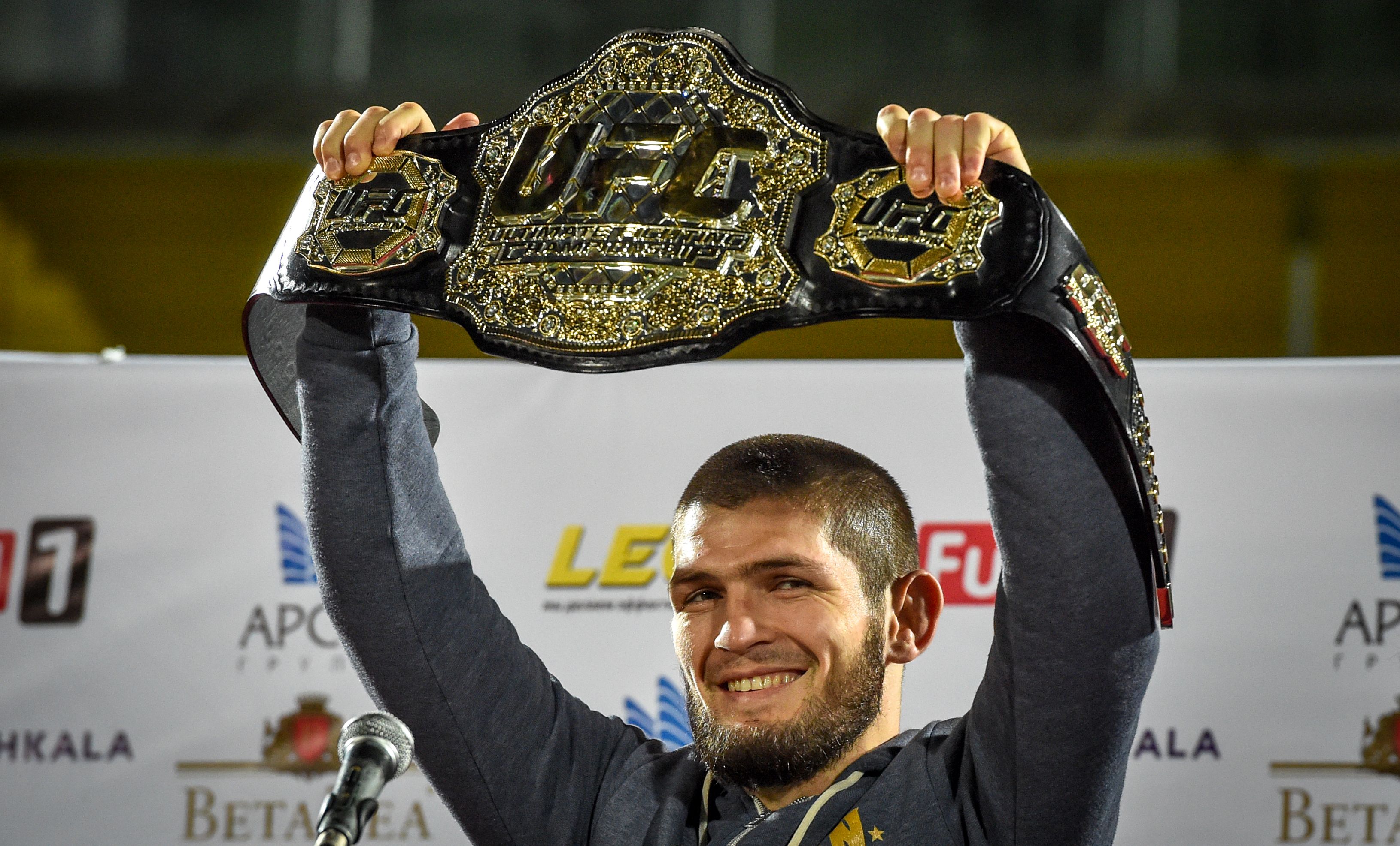 UFC lightweight champion Khabib Nurmagomedov of Russia raises his champions belt upon the arrival in Makhachkala on October 8, 2018. - Nurmagomedov defeated Conor McGregor of Ireland in their UFC lightweight championship bout by way of submission during the UFC 229 event inside T-Mobile Arena on October 6, 2018 in Las Vegas, Nevada. (Photo by Vasily MAXIMOV / AFP) (Photo credit should read VASILY MAXIMOV/AFP/Getty Images)