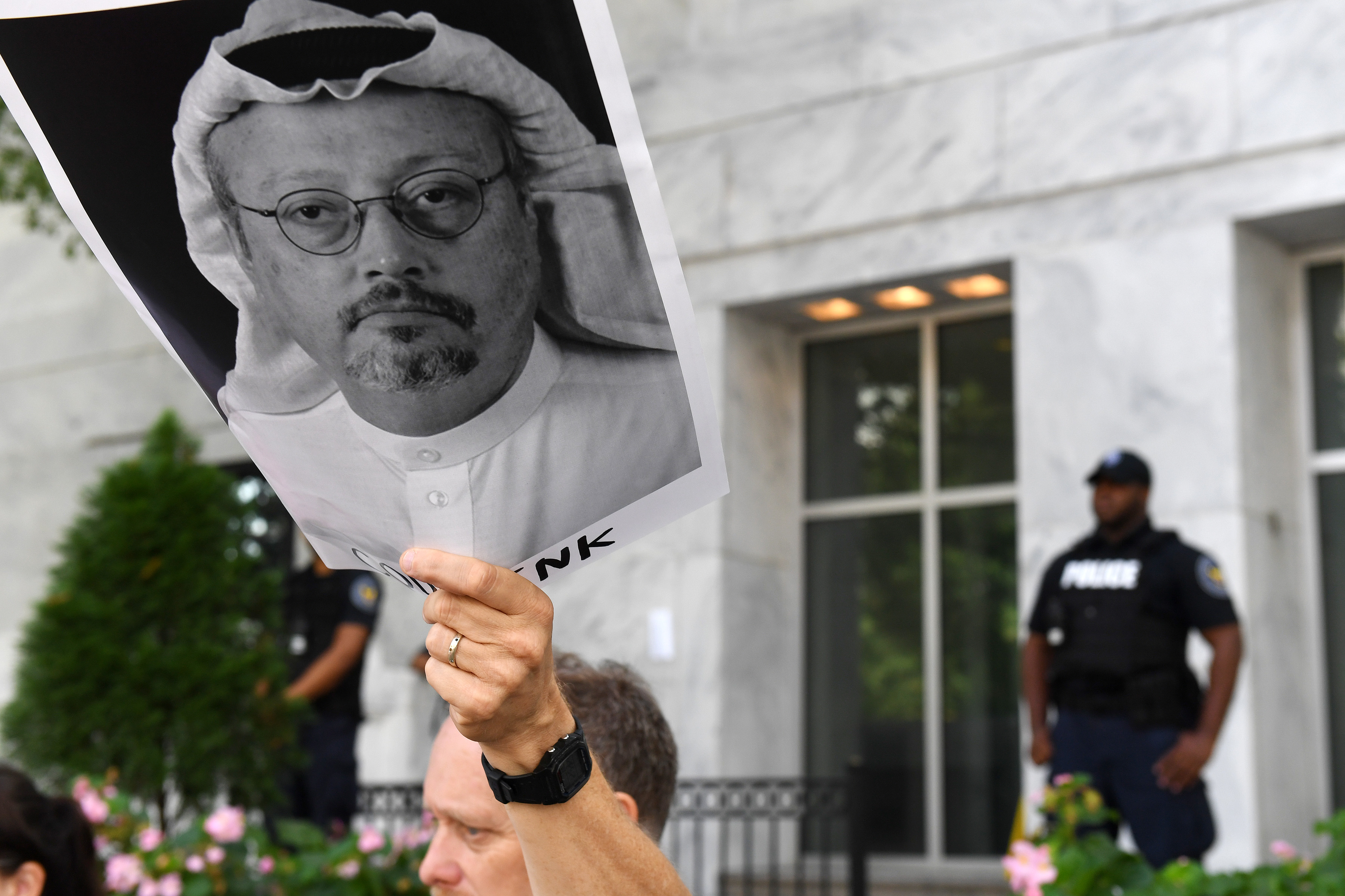 President Trump said Wednesday that while he was worried about the fate of Washington Post columnist Jamal Khashoggi, halting arms sales to Saudi Arabia in response would be a step too far. PICTURED: Michael Beer holds a poster during a rally for Khashoggi, who disappeared after entering the Saudi Consulate in Instanbul. (Photo credit: Matt McClain/The Washington Post via Getty Images)
