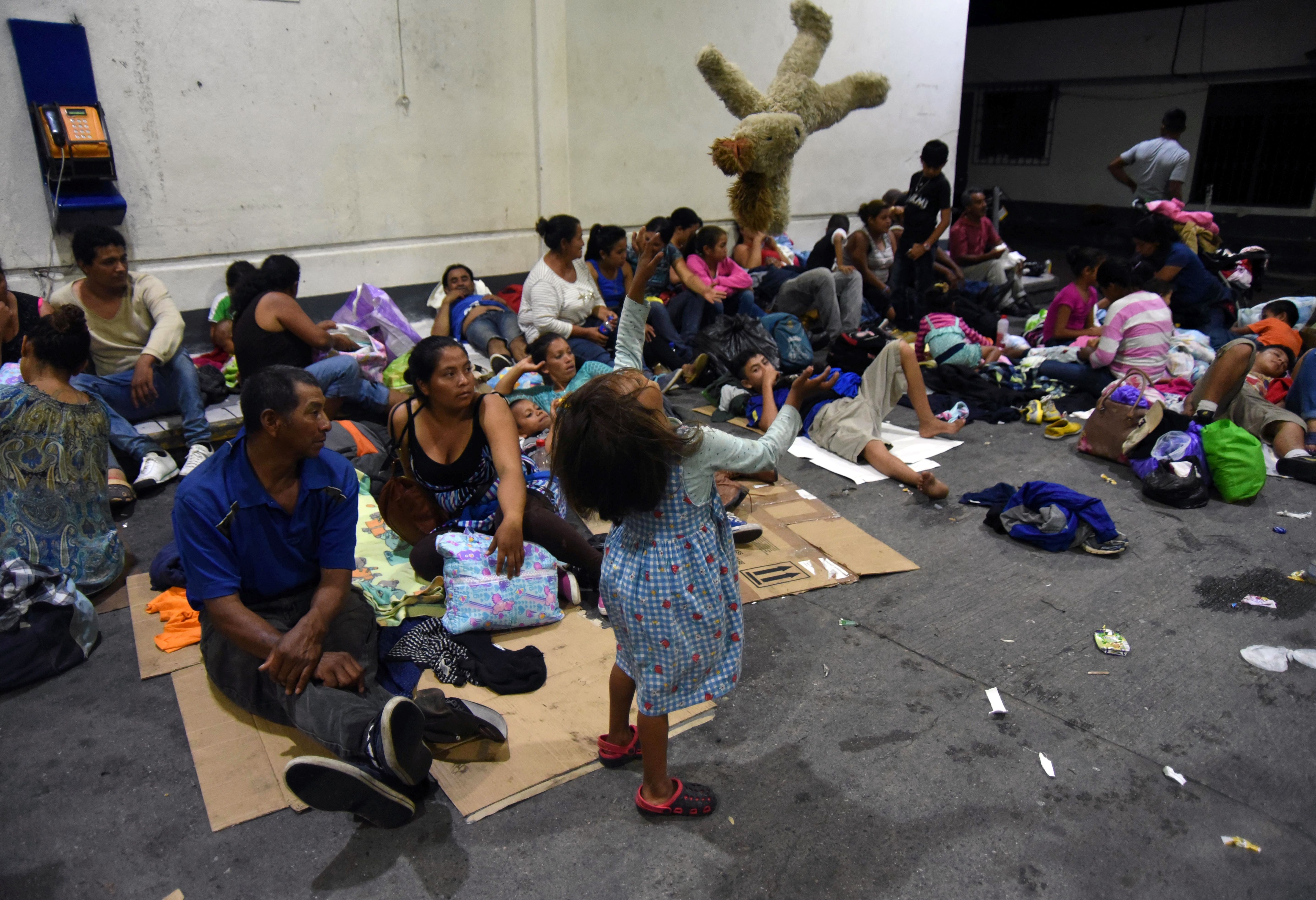 Honduran migrants heading to the United States, take a rest at a gas station in Zacapa, Guatemala, on October 16, 2018. A migrant caravan set out on October 13 from the impoverished, violence-plagued country and was headed north on the long journey through Guatemala and Mexico to the US border. President Donald Trump warned Honduras he will cut millions of dollars in aid if the group of about 2,000 migrants is allowed to reach the United States. (Photo credit: ORLANDO ESTRADA/AFP/Getty Images)