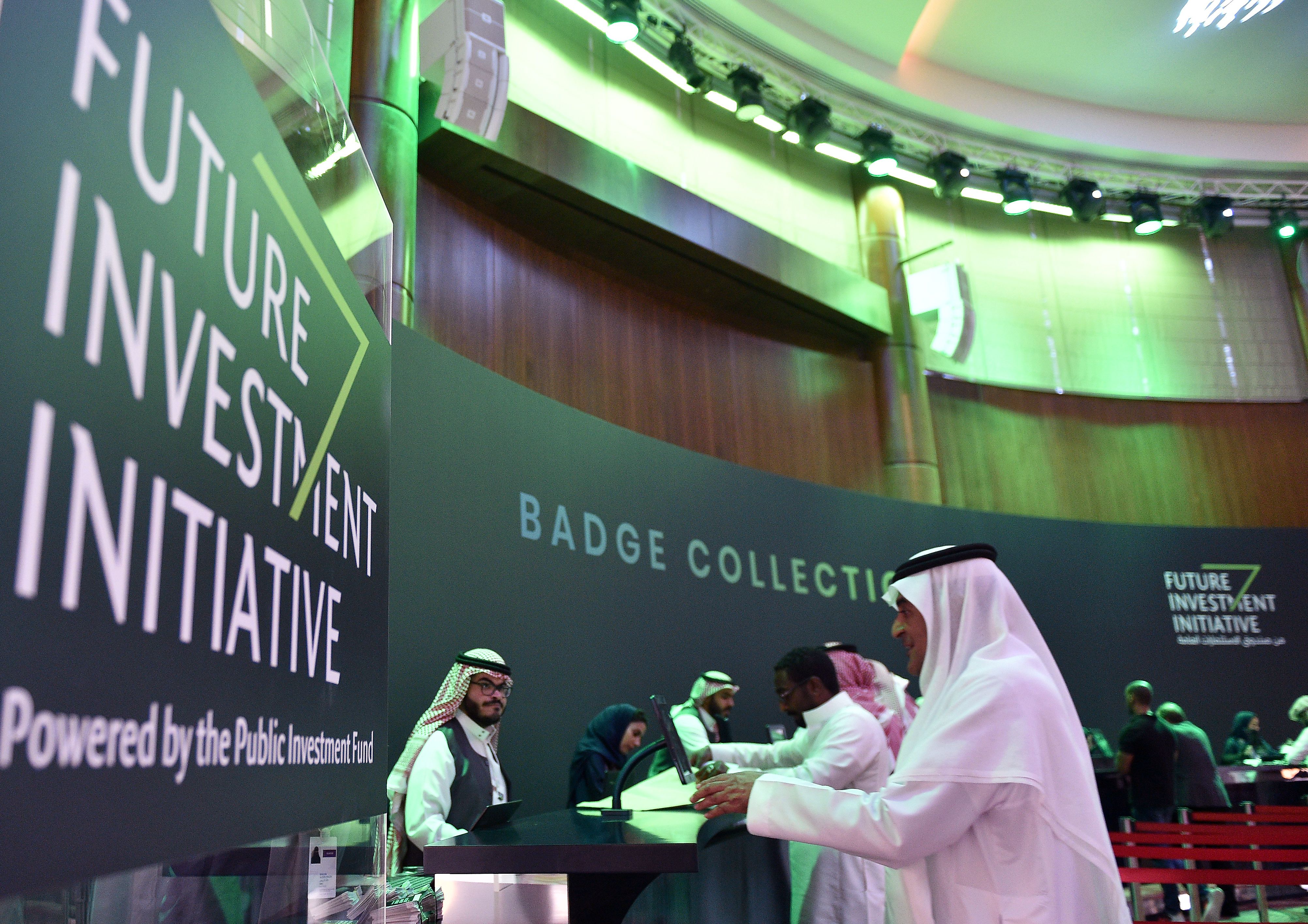 A picture taken on October 22, 2018 shows Saudi journalists collecting their press badges at the press center of the Future Investment Initiative FII ahead of the conference which will take place in Riyadh from 23-25 October. - Saudi Arabia will host a key investment summit overshadowed by the killing of critic Jamal Khashoggi that has prompted a wave of policymakers and corporate giants to withdraw. (Photo by FAYEZ NURELDINE / AFP) (Photo credit should read FAYEZ NURELDINE/AFP/Getty Images)