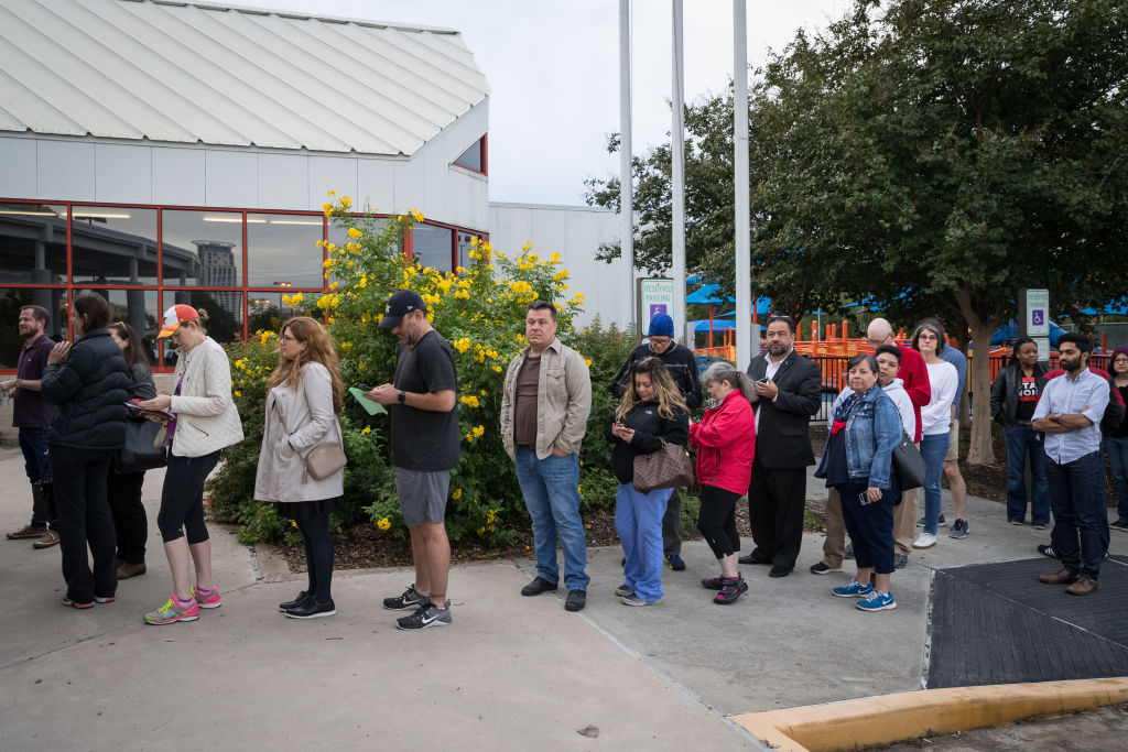 People wait in line to vote at a Houston polling place