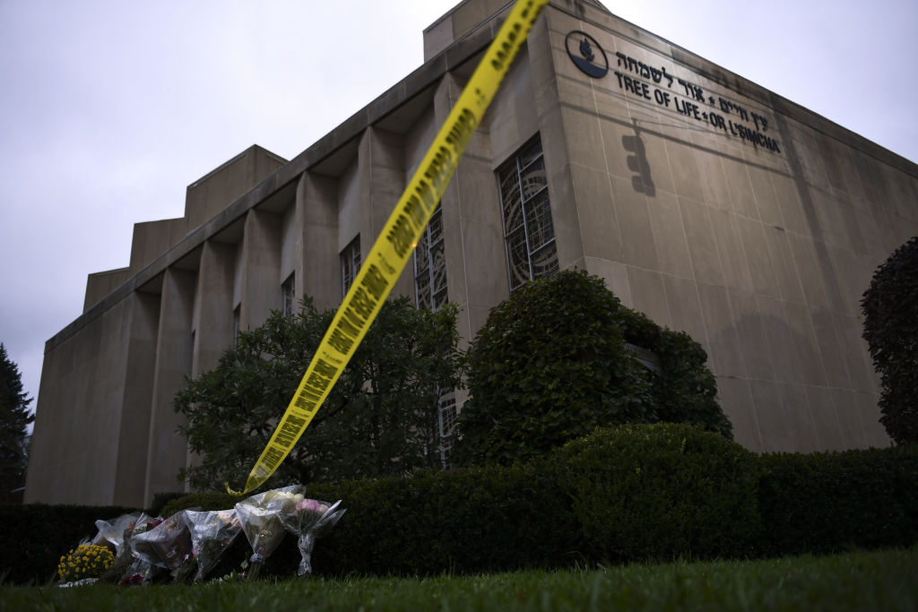 Police tape and memorial flowers are seen on October 28, 2018 outside the Tree of Life Synagogue after a shooting there left 11 people dead in the Squirrel Hill neighborhood of Pittsburgh on October 27, 2018. CREDIT: BRENDAN SMIALOWSKI/AFP/Getty Images