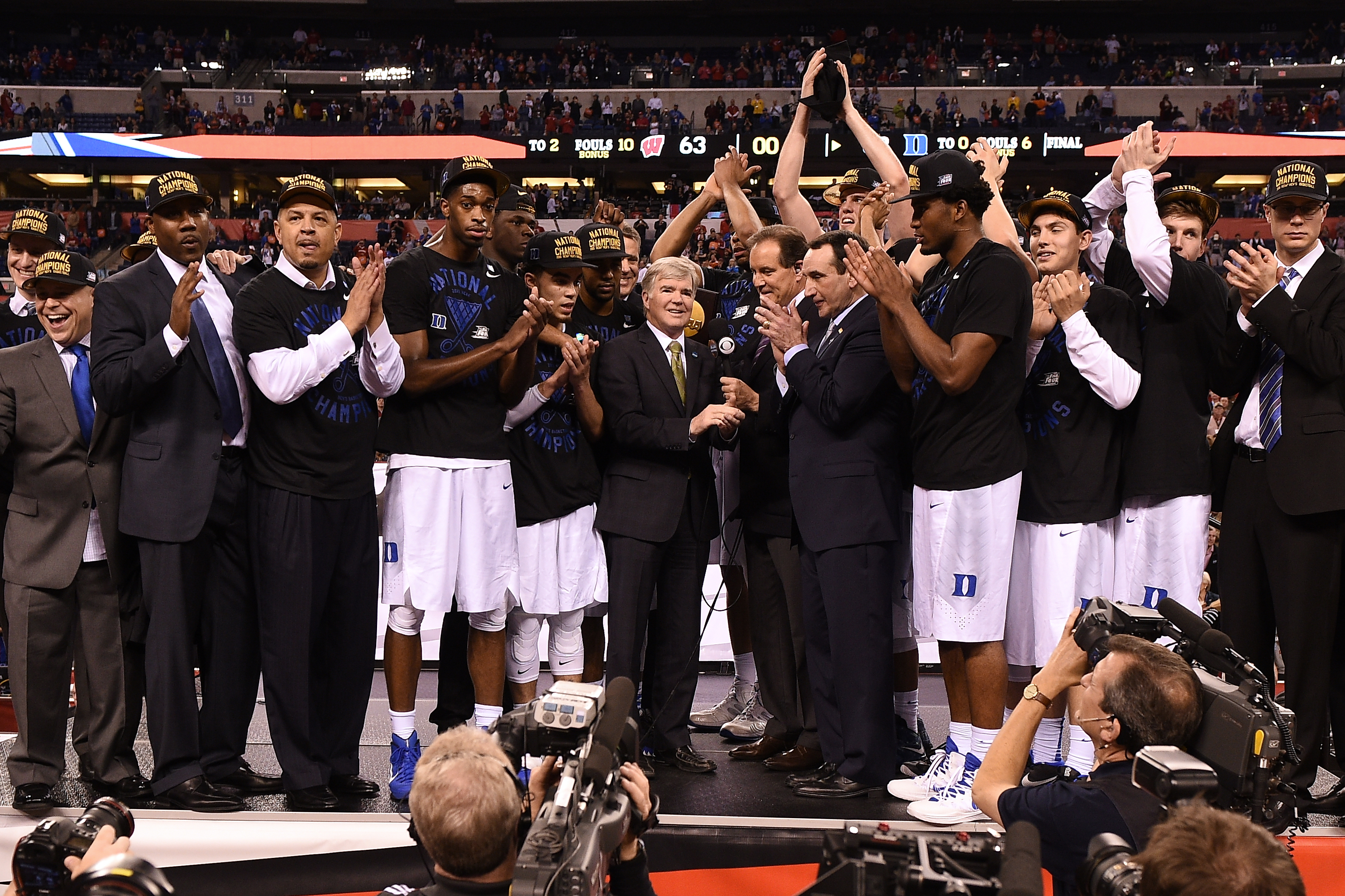 INDIANAPOLIS, IN - APRIL 06: Head coach Mike Krzyzewski of the Duke Blue Devils speaks to NCAA President Dr. Mark Emmert and CBS correspondent Jim Nantz after defeating the Wisconsin Badgers during the NCAA Men's Final Four Championship at Lucas Oil Stadium on April 6, 2015 in Indianapolis, Indiana. Duke defeated Wisconsin 68-63. (Photo by Lance King/Getty Images)