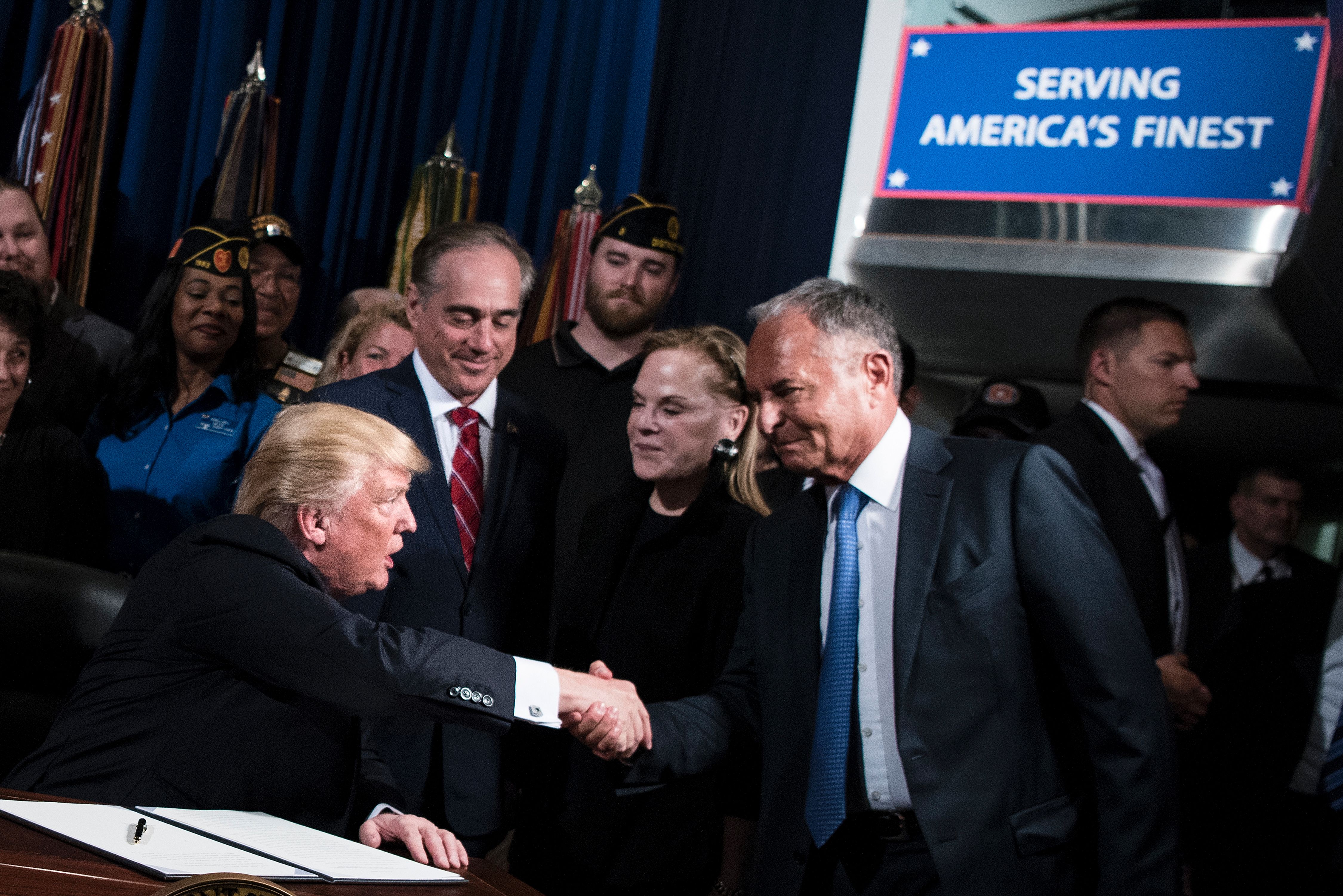 US President Donald Trump shakes hands with Ike Perlmutter, CEO of Marvel Entertainment, before signing an executive order at the US Department of Veterans Affairs in Washington, D.C. on April 27, 2017. CREDIT: BRENDAN SMIALOWSKI/AFP/Getty Images