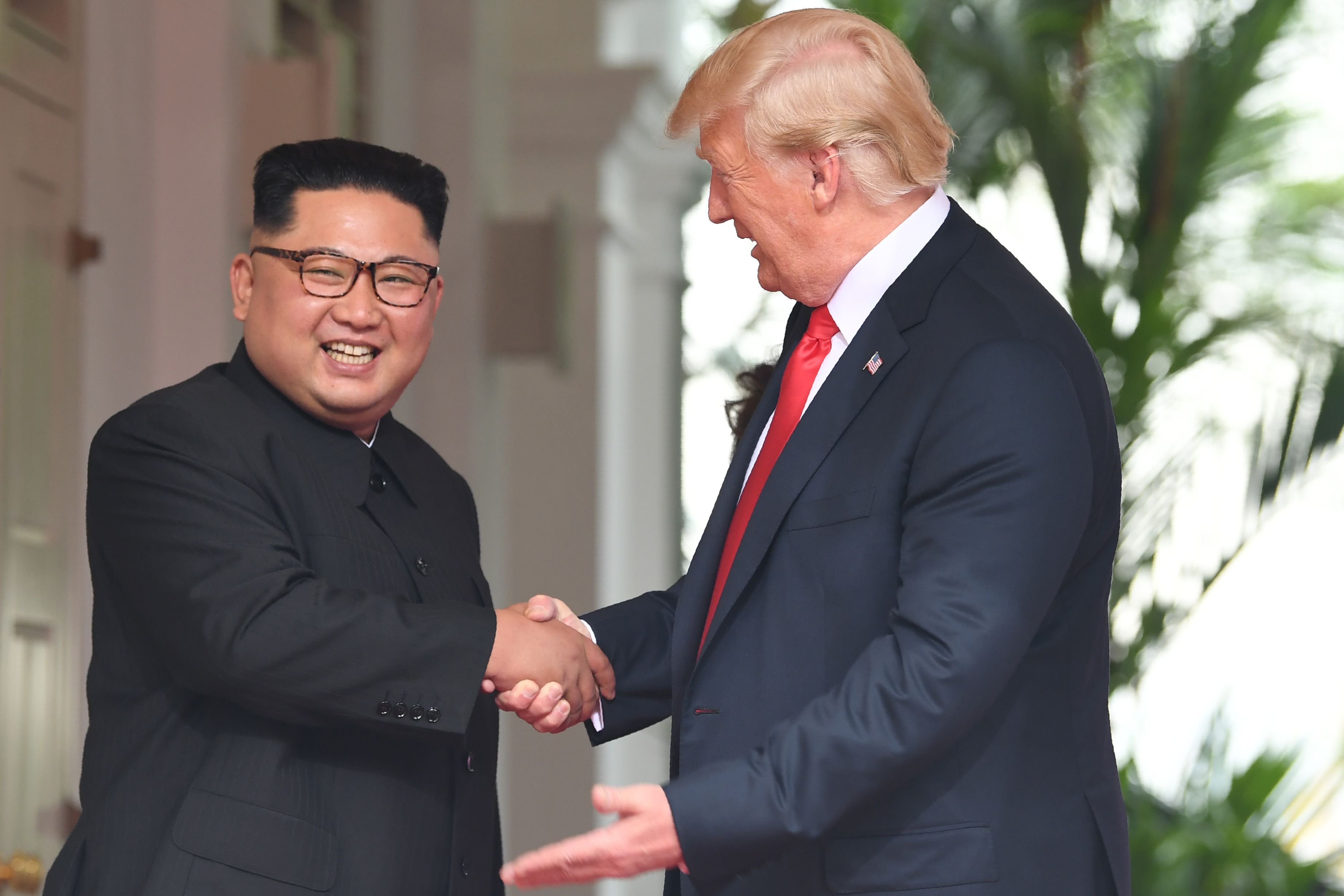 North Korea's leader Kim Jong-un shakes hands with President Donald Trump at the start of their summit in Singapore on June 12, 2018. CREDIT: Saul Loeb/AFP/Getty Images.