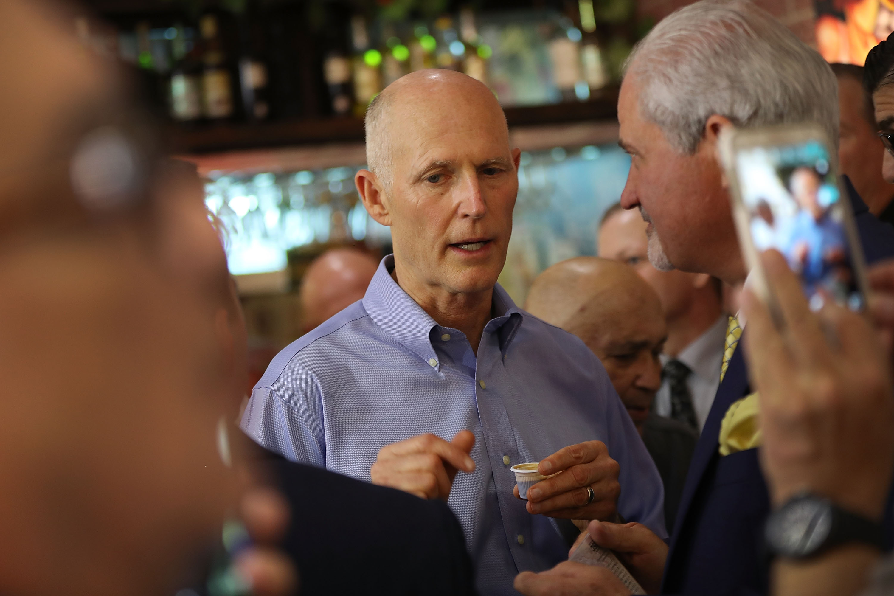 Florida Governor Rick Scott greets people as he makes a campaign stop. CREDIT: Joe Raedle/Getty Images
